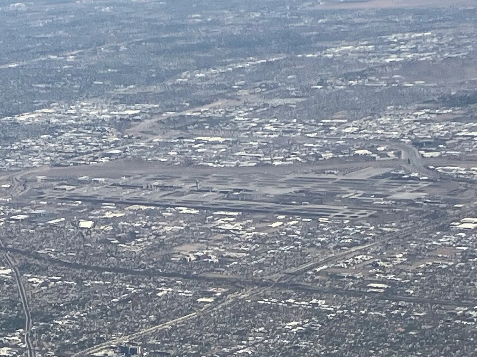 Aerial photograph of Phoenix Sky Harbor International Airport showing parallel runways, terminal complexes, and surrounding desert terrain.