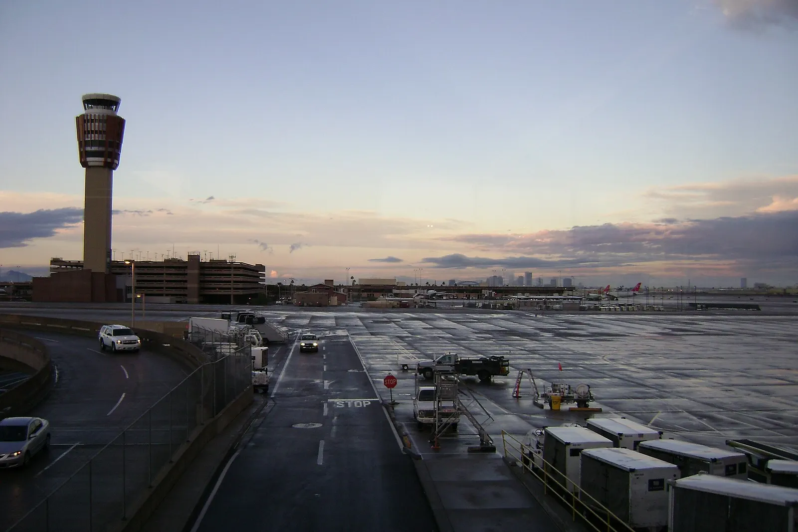 Terminal 3 at Phoenix Sky Harbor Airport photographed from Terminal 4, with the downtown Phoenix skyline visible on the horizon.