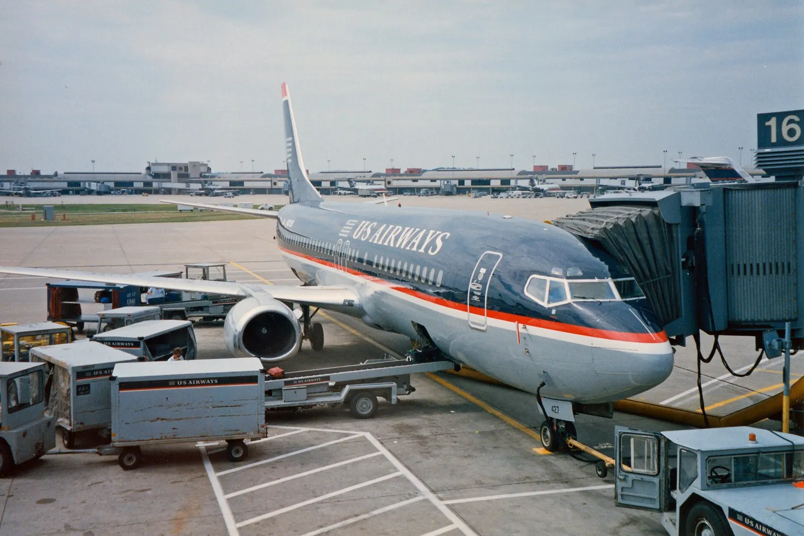 N427US, a Boeing 737-4B7 at Gate 16 on Concourse A at Pittsburgh International Airport. More at The Schumin Web : <a href=" https://www.schuminweb.com/odds-and-ends/canada-trip-part-1/ " rel="noreferrer nofollow">www.schuminweb.com/odds-and-ends/canada-trip-part-1/</a> Ben Schumin is a p