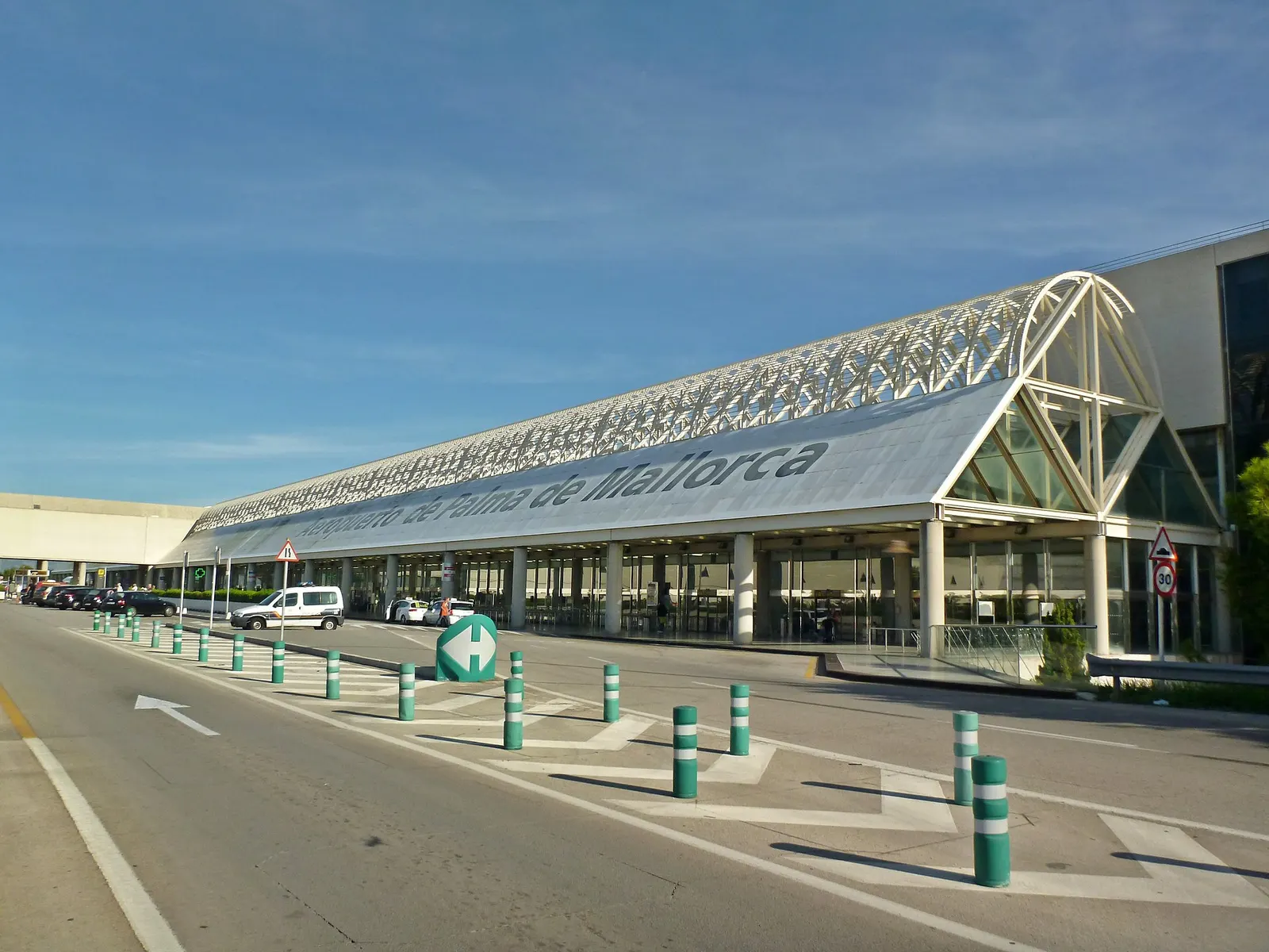 The glass-fronted exterior of Terminal C at Palma de Mallorca Airport, with the building facade and entrance area visible.