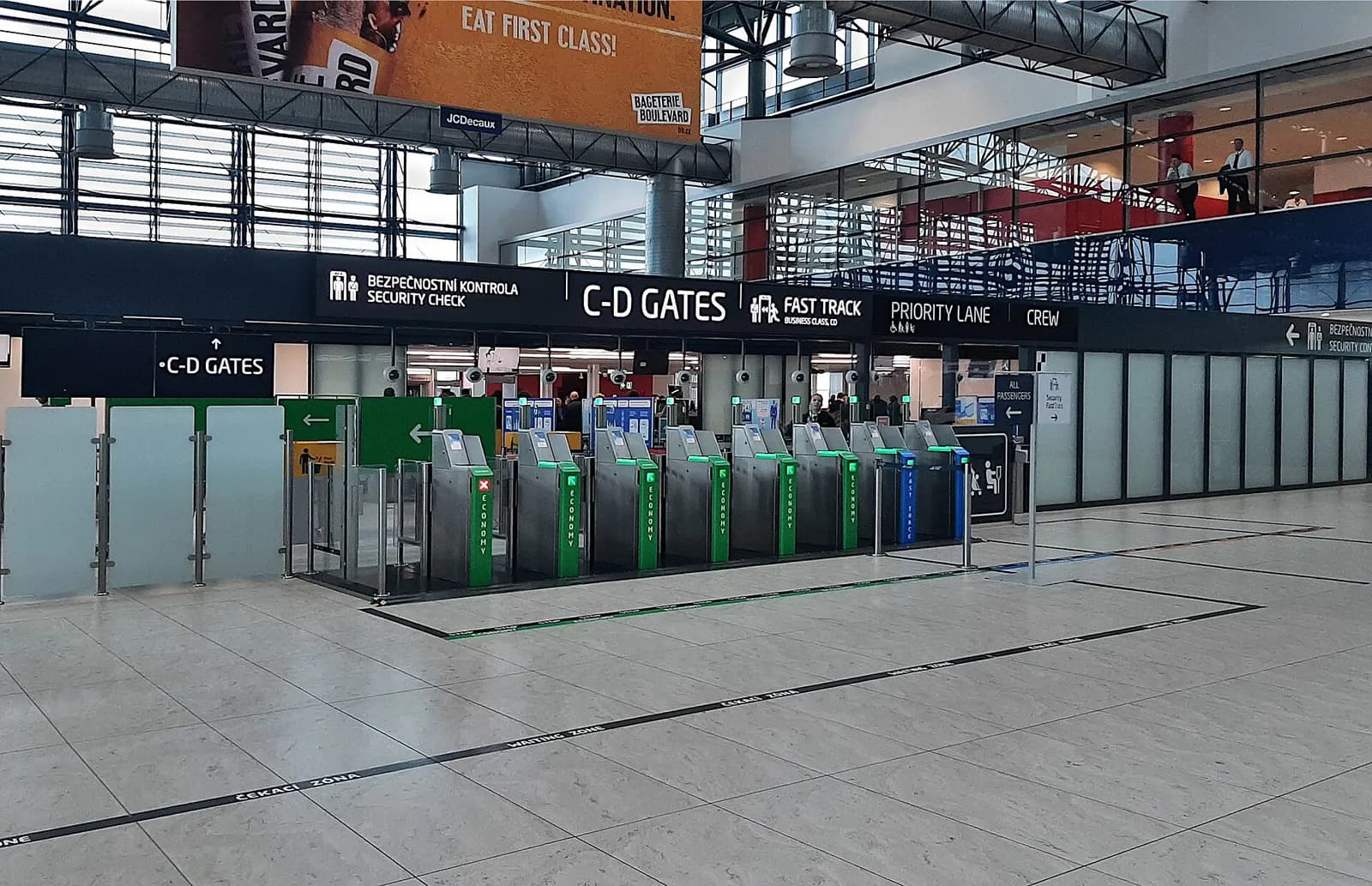 Passengers queuing at the security screening lanes inside Terminal 2 at Václav Havel Airport Prague.