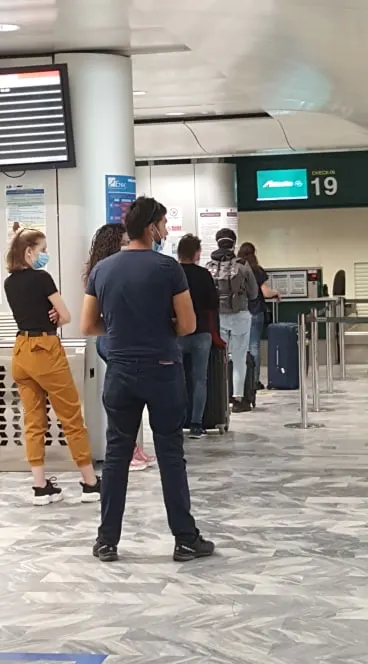 Check-in desks in the departures hall at Pisa Galileo Galilei Airport.