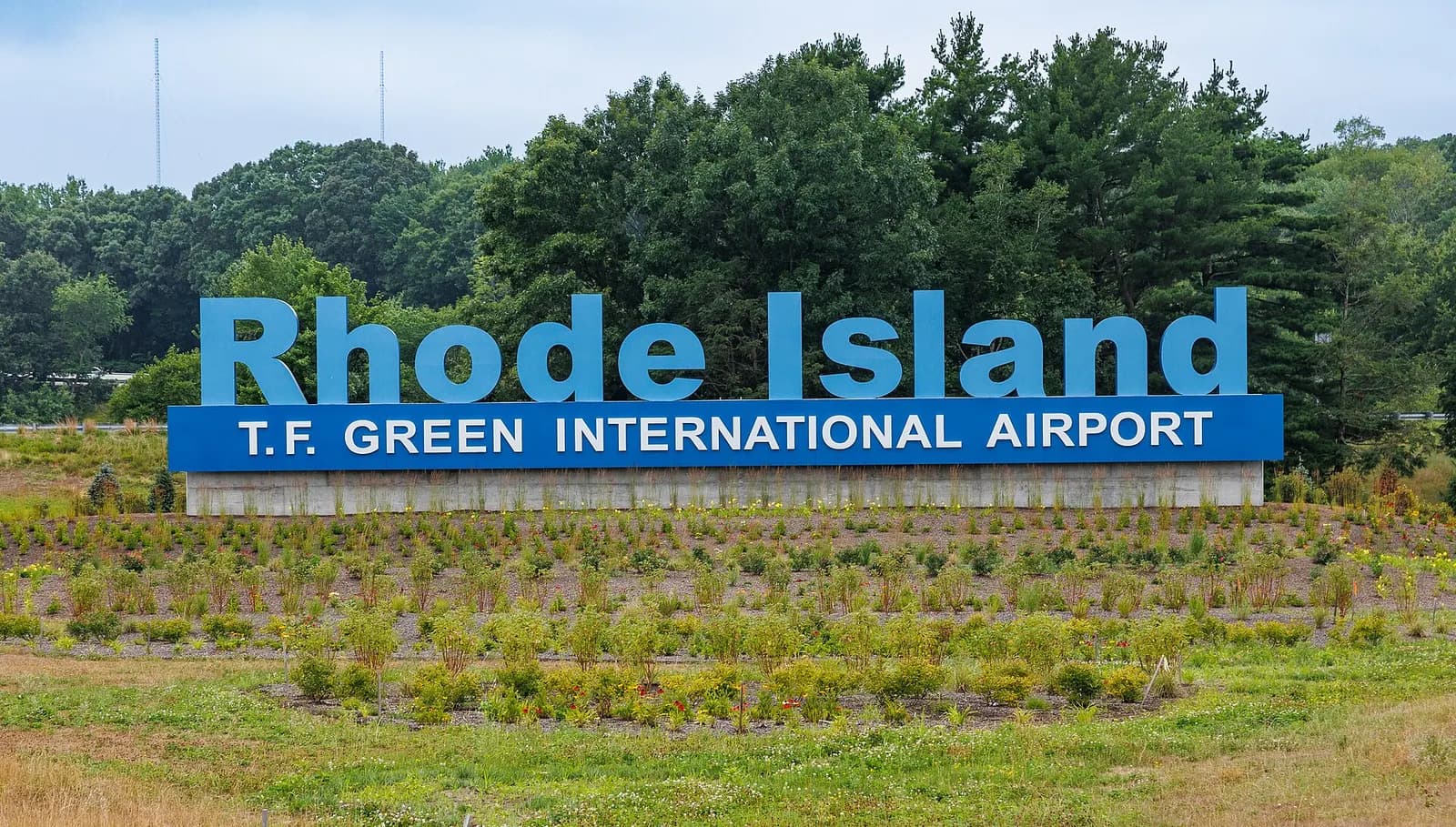 Roadside monument sign reading Rhode Island T.F. Green International Airport.