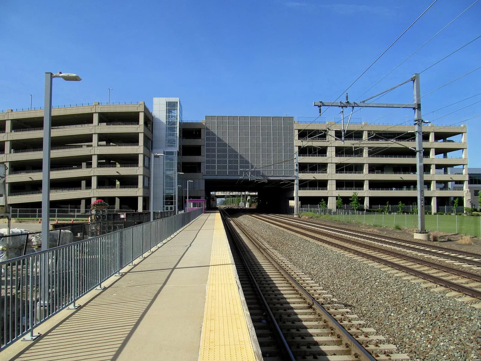 MBTA T.F. Green Airport / Warwick station platform with the InterLink parking garage spanning the tracks.