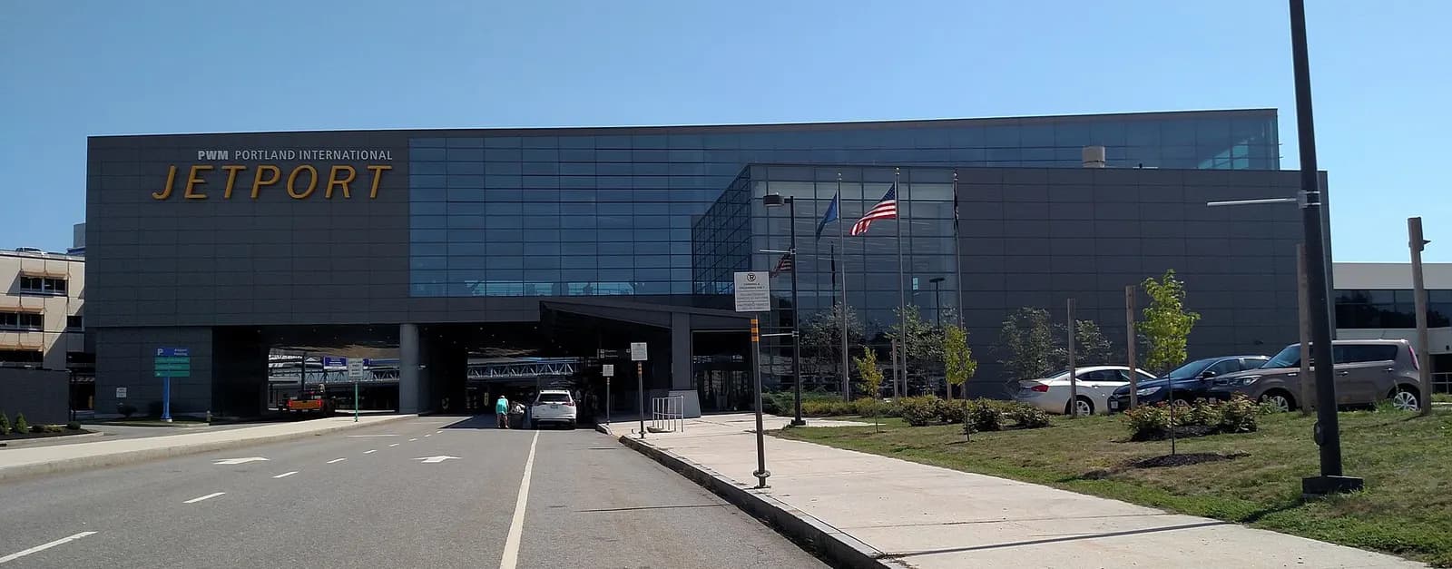 Long facade of the Portland International Jetport terminal with jet bridges.