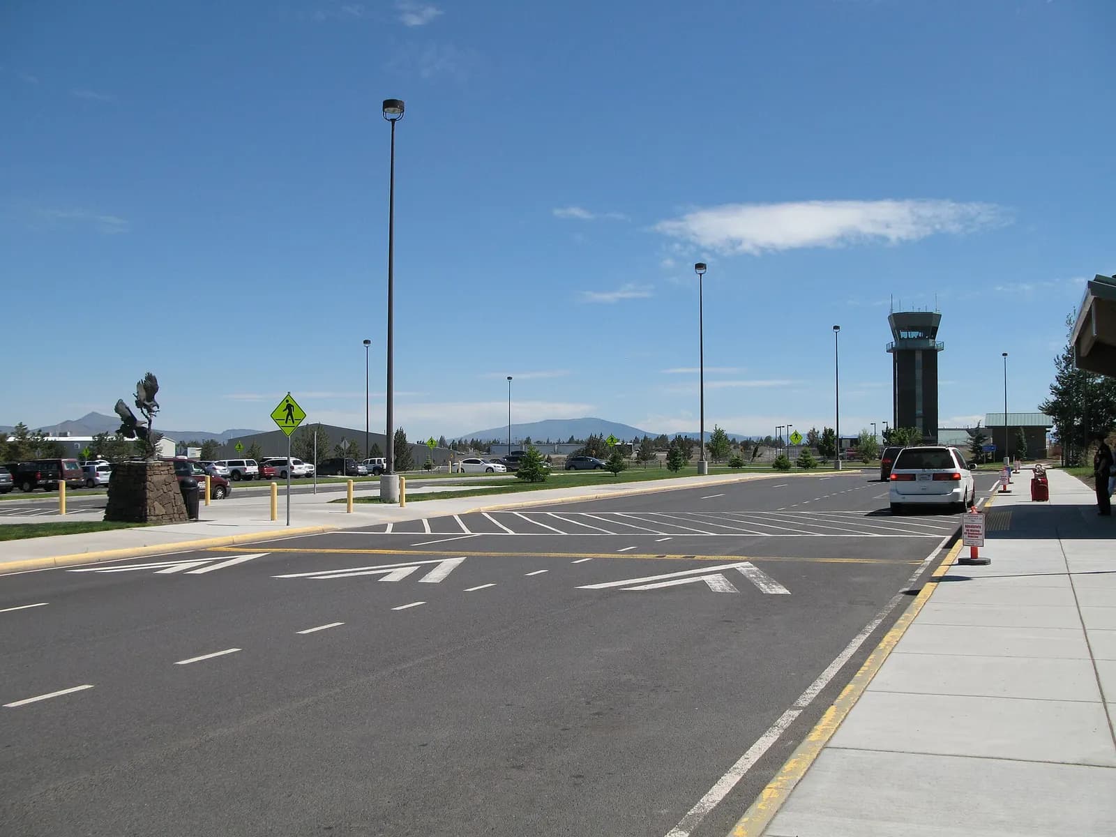 Landside curb at Redmond Municipal Airport in June 2011, with the eagle statue and historic HighDesert POINT stop.