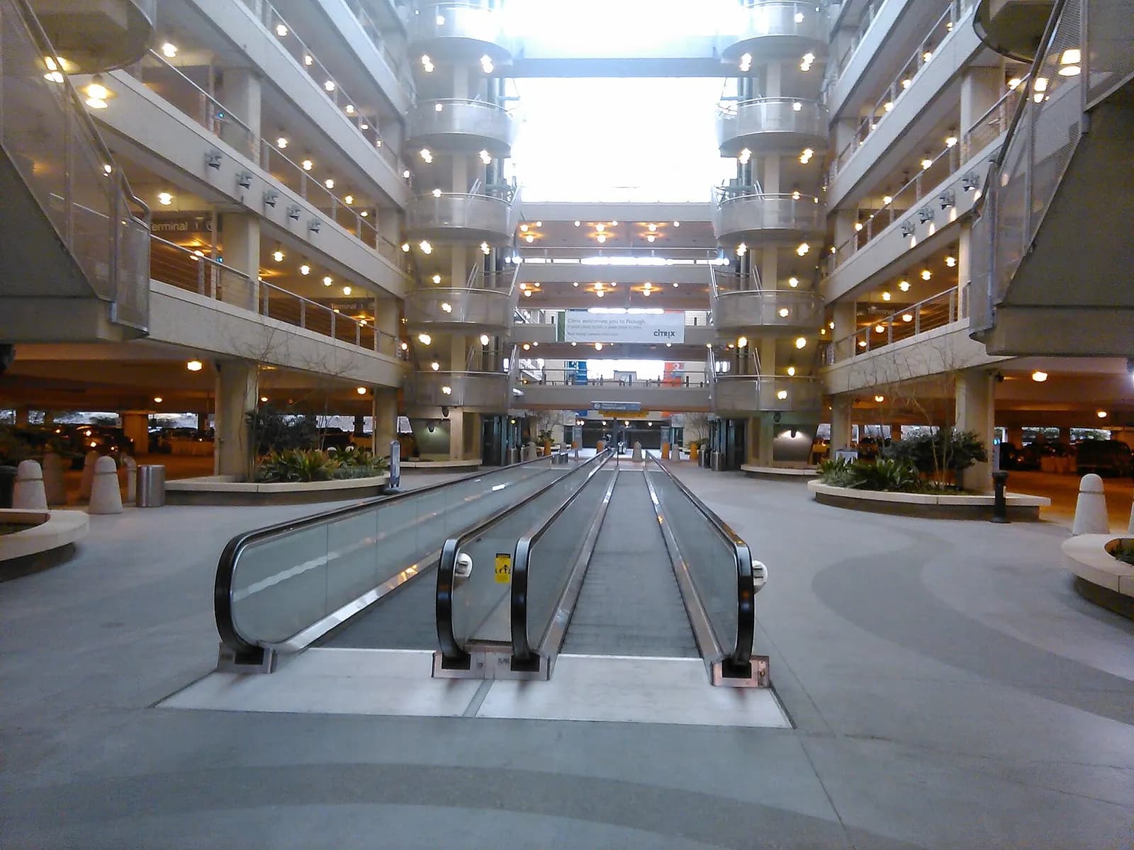 The multi-level parking garage at RDU with concrete structure, open levels, and vehicles parked near the terminal access roads.