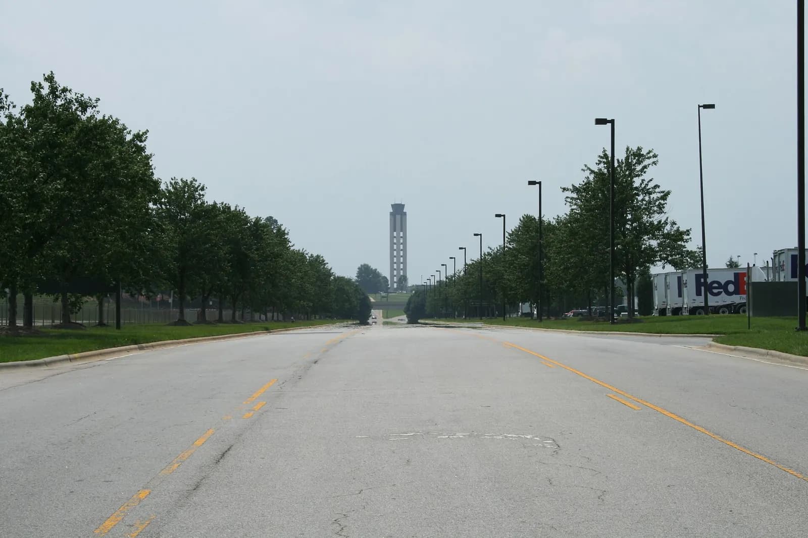 A southwest view along International Drive toward RDU's air traffic control tower, with the FedEx cargo terminal visible on the right.
