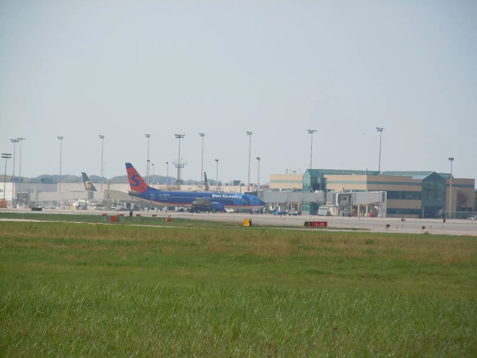 Main Terminal exterior at Chicago Rockford International Airport with a passenger jet at the gate.