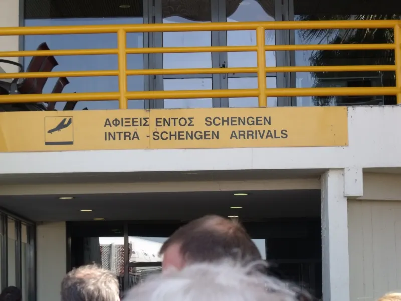 Schengen arrivals corridor and passenger wayfinding at Rhodes Airport.