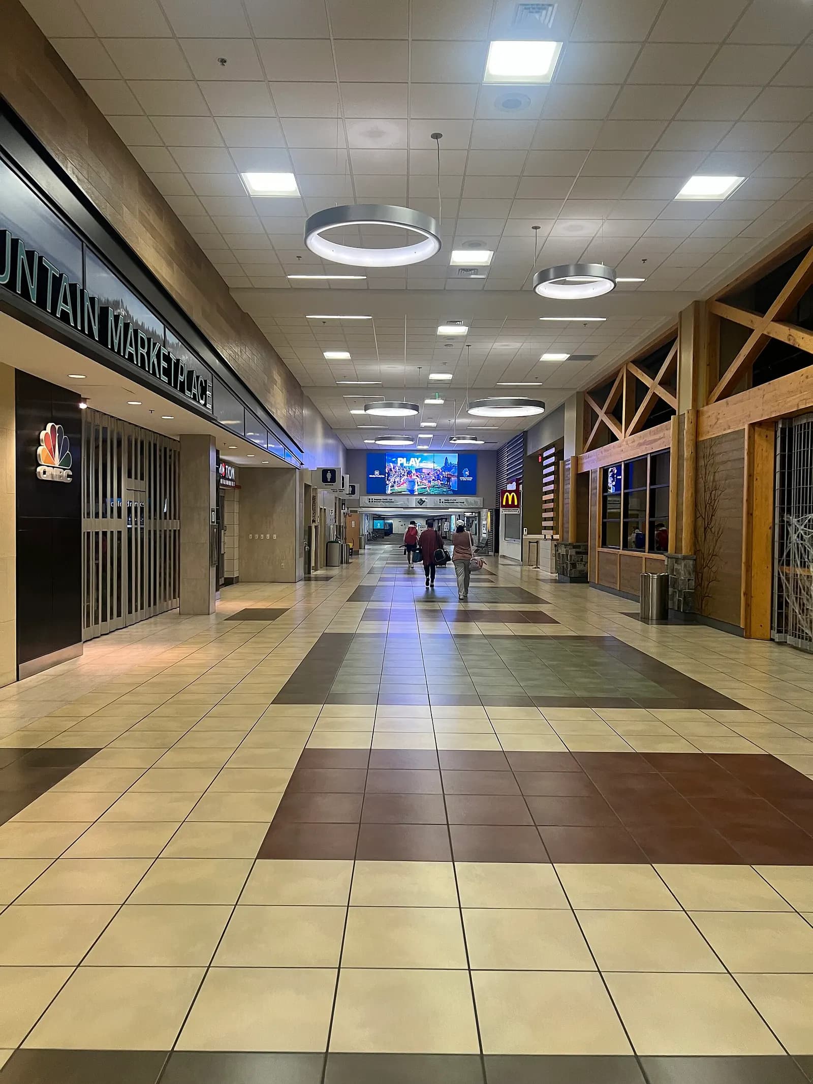 High Mountain Marketplace corridor toward CNBC News and McDonald’s at Reno-Tahoe
