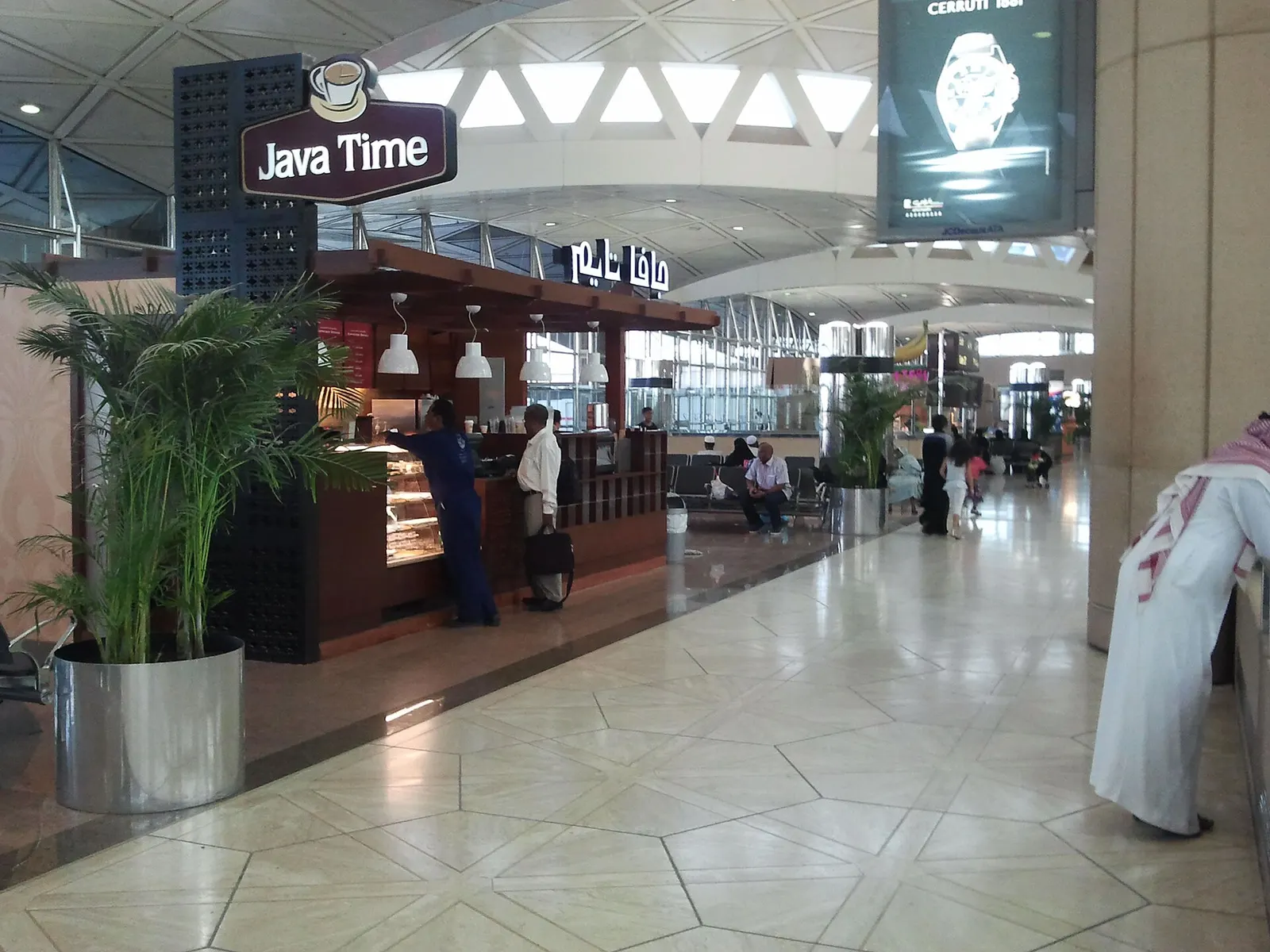 Java Time coffee shop counter and seating inside a King Khalid International Airport terminal.