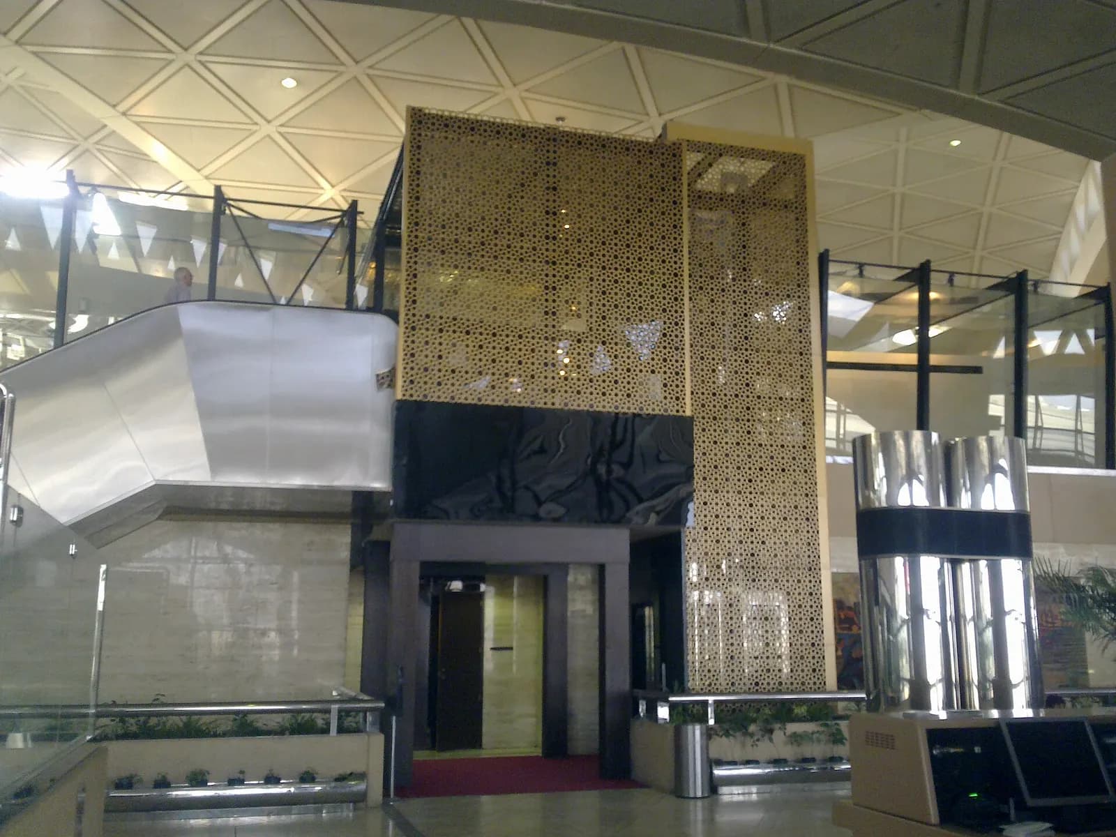 Exterior of King Khalid International Airport terminal buildings and surrounding apron seen from ground level in Riyadh.