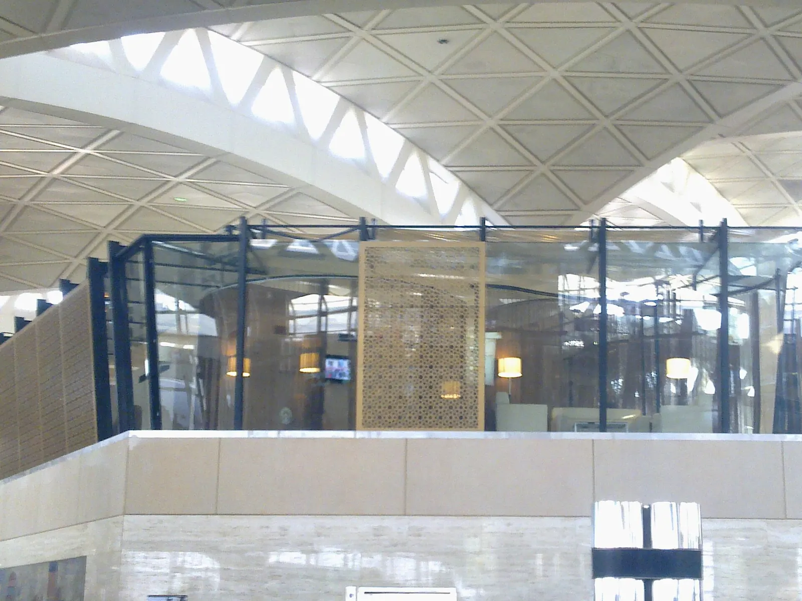 Furnished seating area inside the Premier lounge in Terminal 1 at King Khalid International Airport.