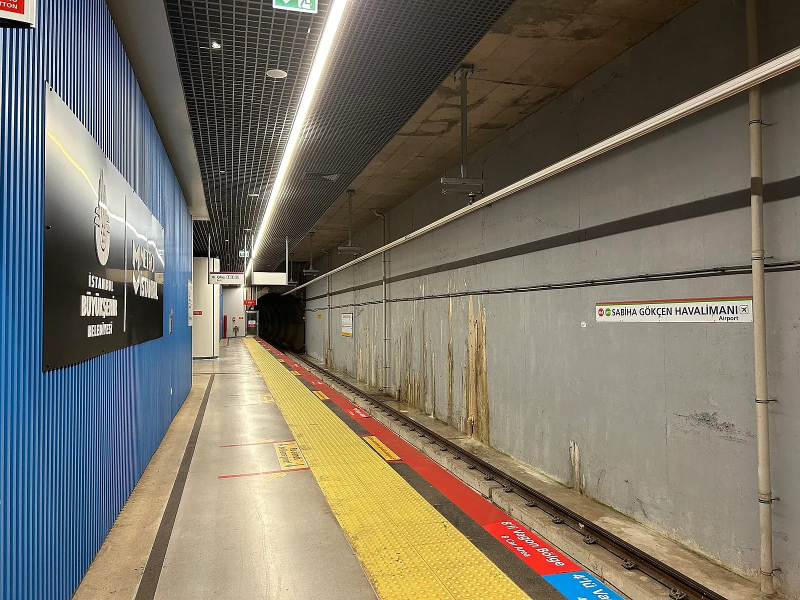 The Sabiha Gökçen Airport metro station with platform canopies and signage for the M4 and M10 lines.