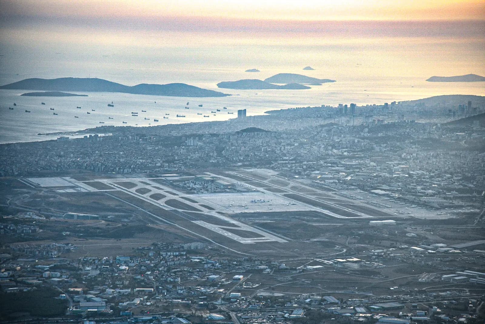 The main terminal buildings and control tower of Istanbul Sabiha Gökçen International Airport viewed from the apron on a clear day.