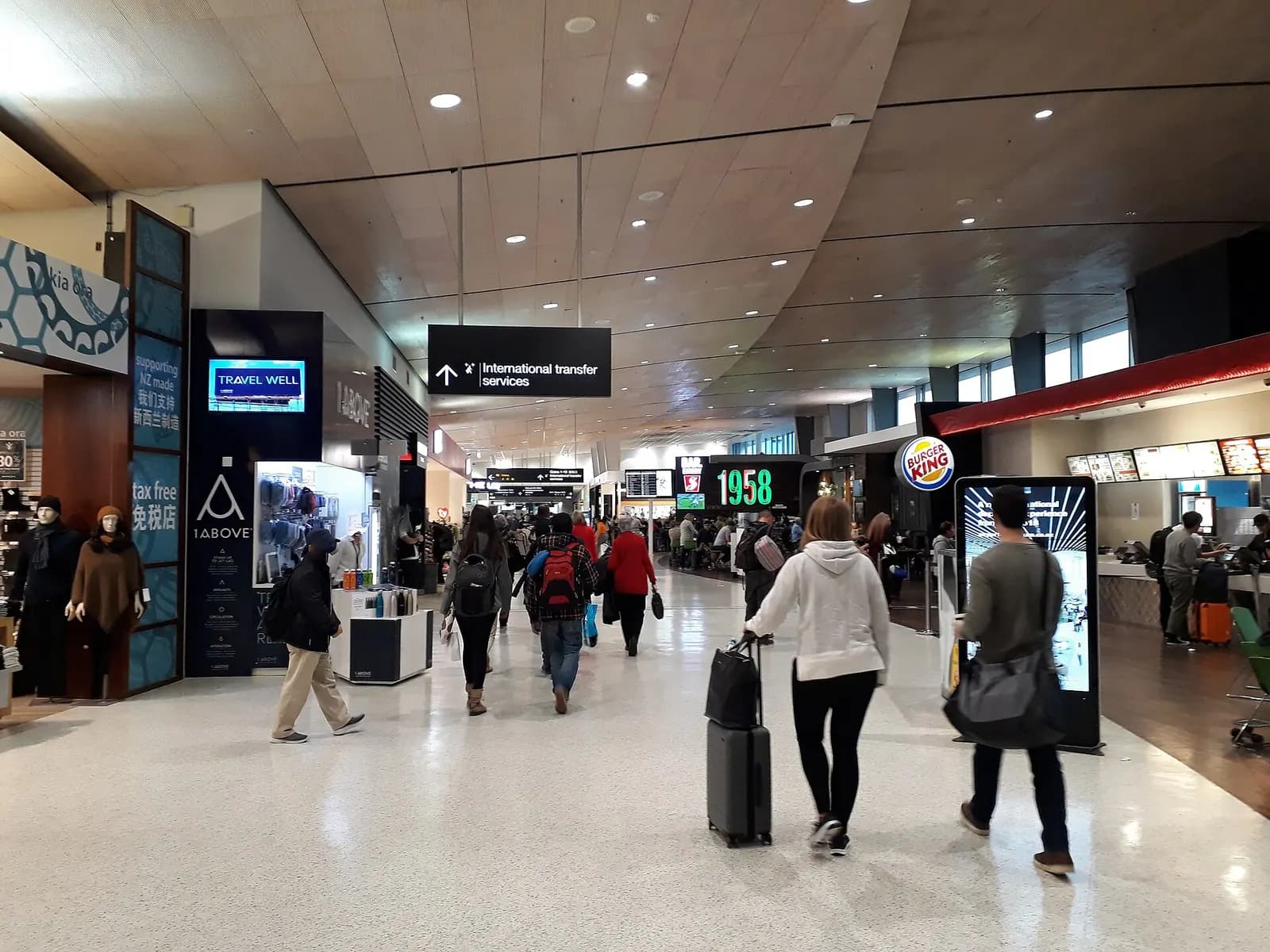 The interior of domestic Terminal 1 with airline counters and passengers in the public concourse.