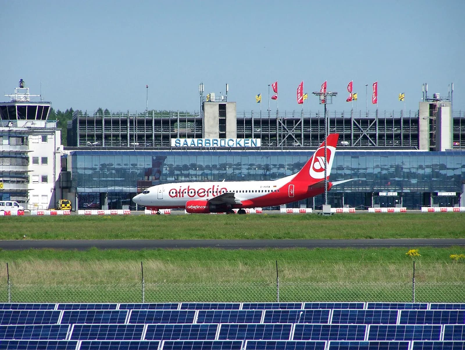 Aircraft on the apron in front of Saarbrücken Airport terminal.