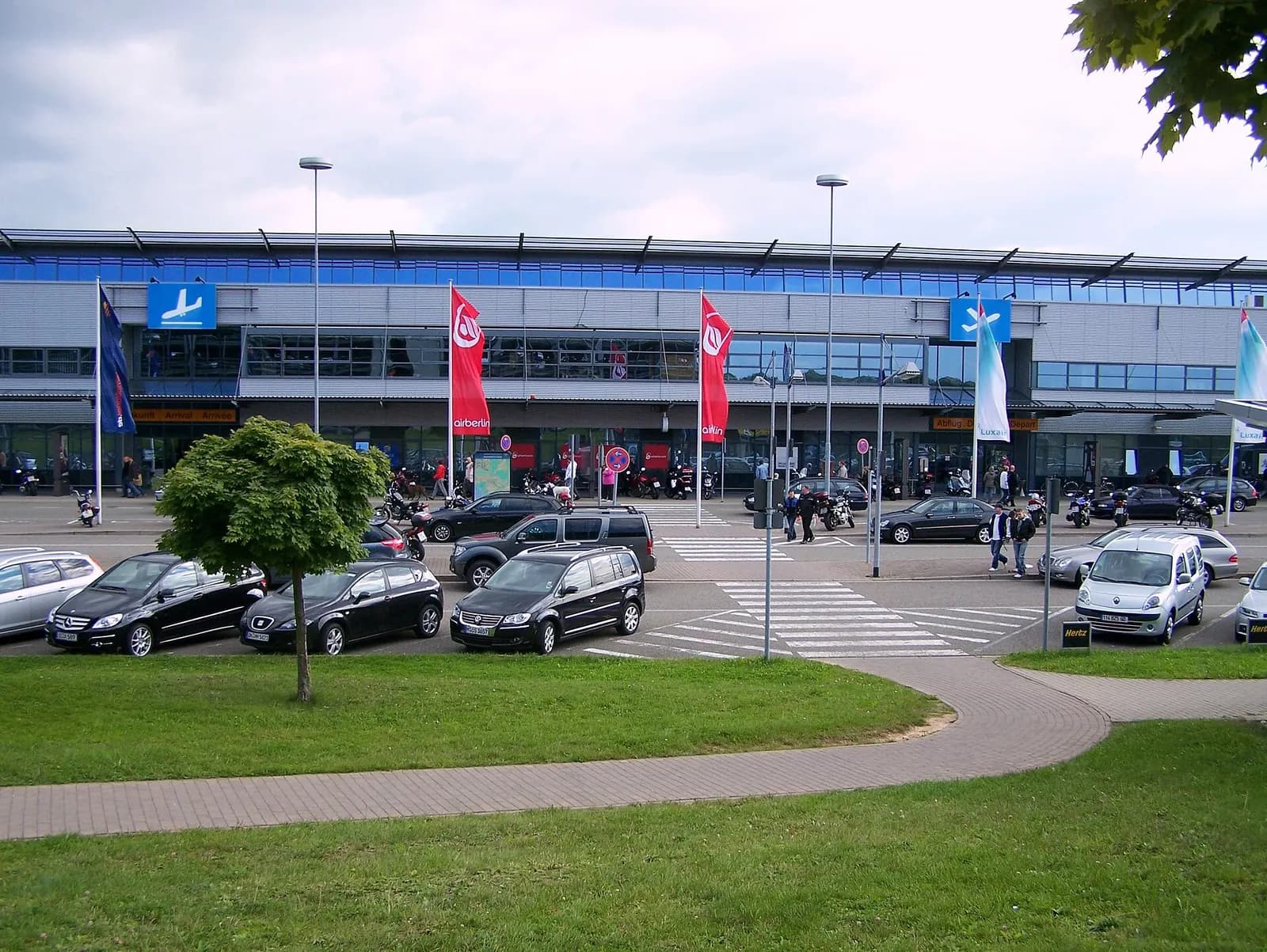 Landside view of Saarbrücken Airport terminal building and forecourt.