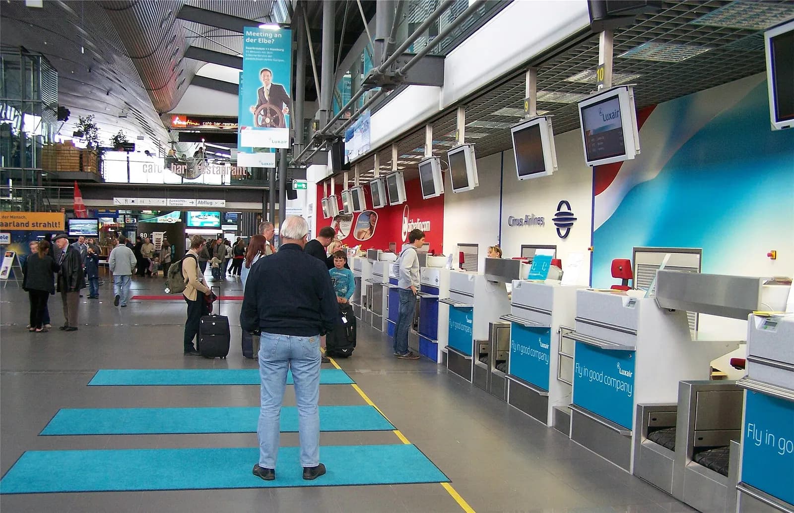 Check-in desks inside Saarbrücken Airport terminal.