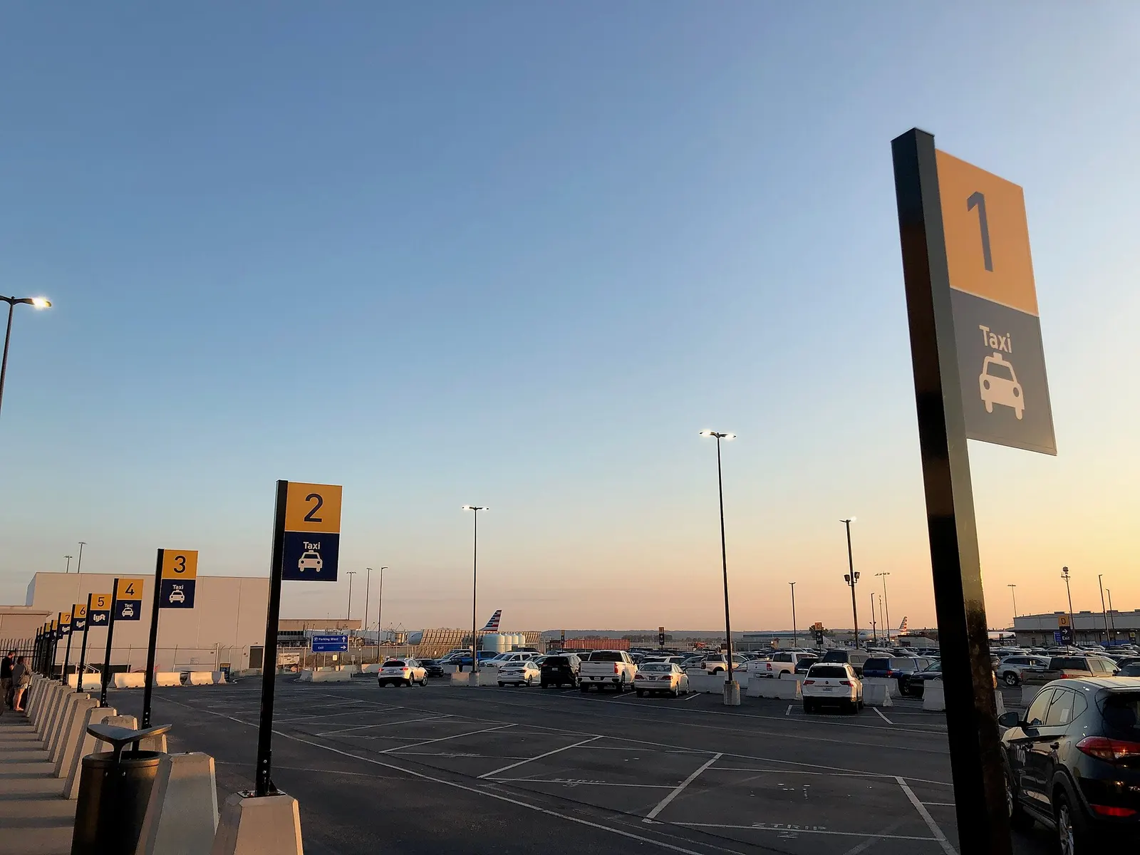 Numbered taxi and rideshare stalls on the west side of Louisville Muhammad Ali International Airport