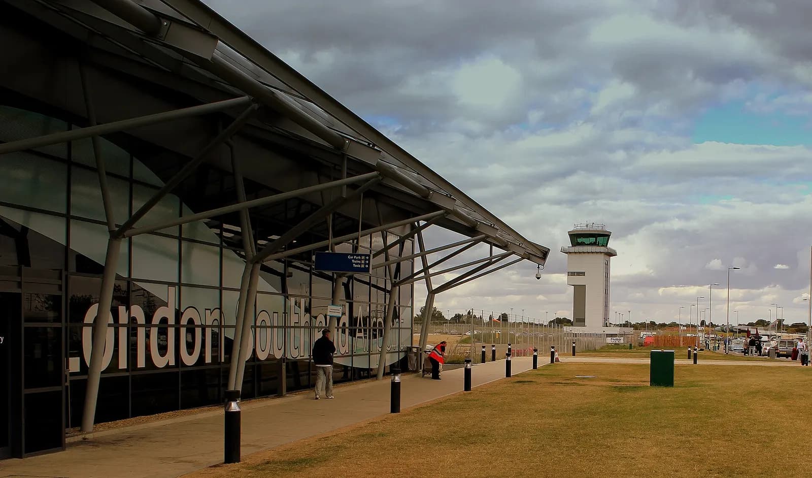 London Southend Airport terminal canopy with car park, trains and taxis sign