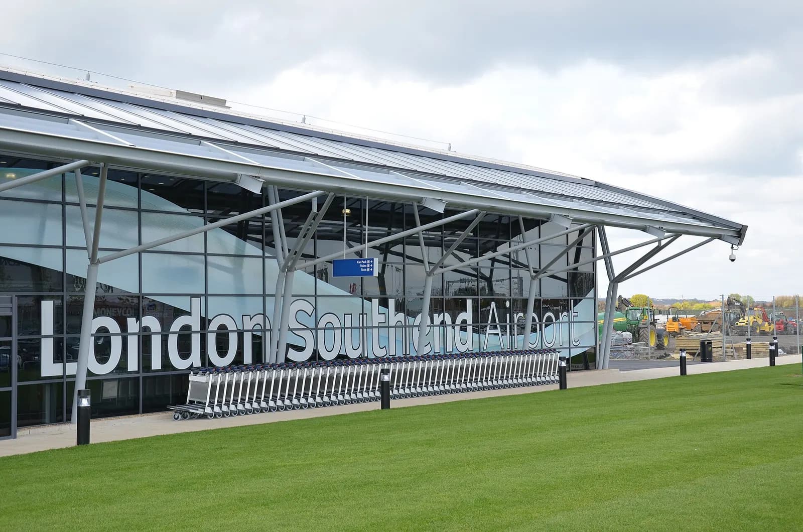 London Southend Airport terminal exterior with luggage trolleys lined up