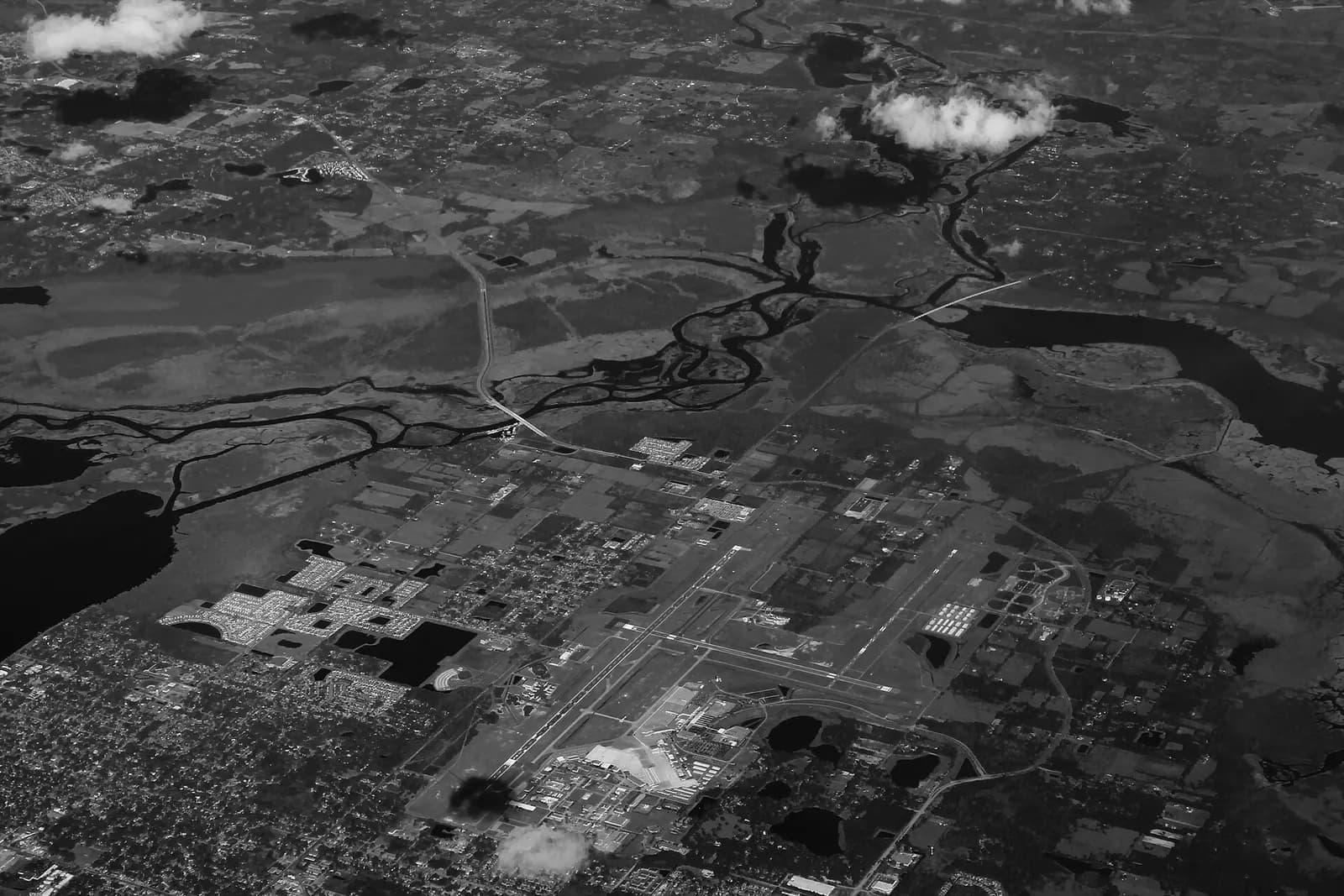 Aerial view of Orlando Sanford International Airport runways and civil terminal campus, looking across the airfield.