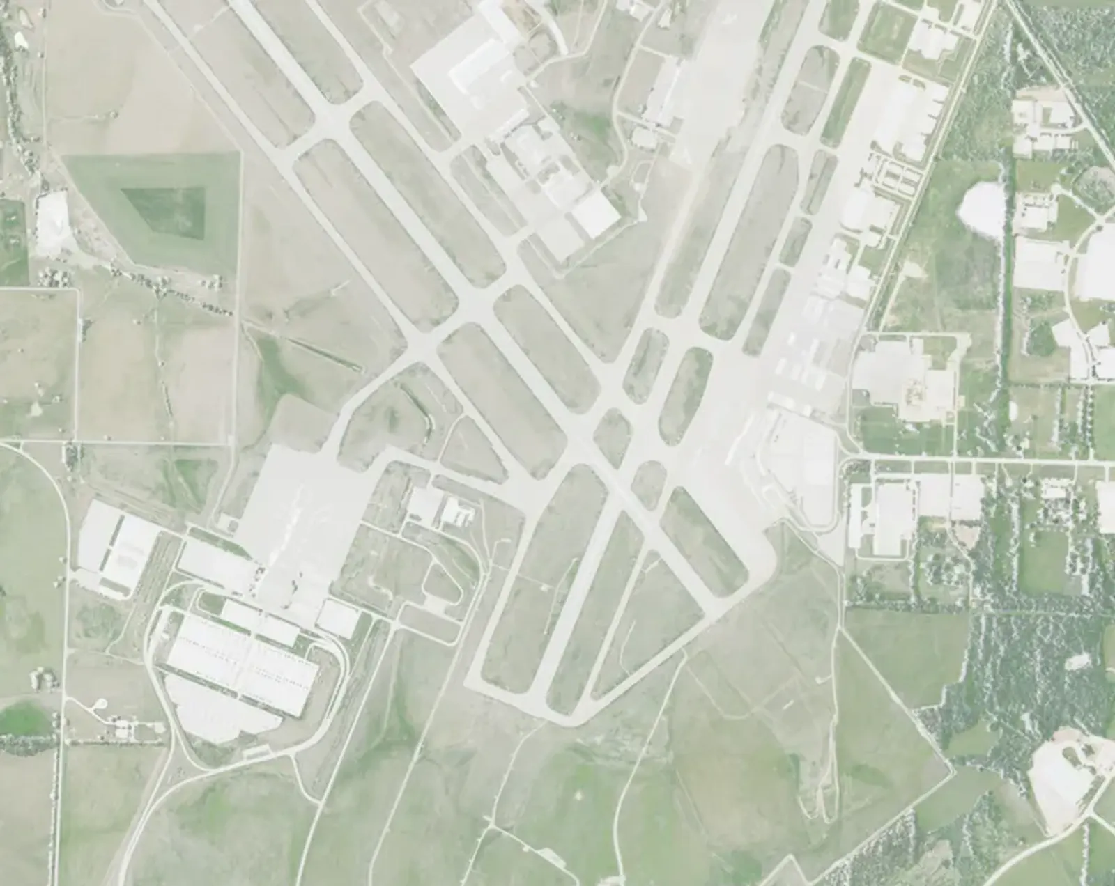 2020 USDA NAIP aerial cropped to the Springfield-Branson National Airport civil campus, showing the intersecting runways and midfield terminal northwest of Springfield, Missouri.