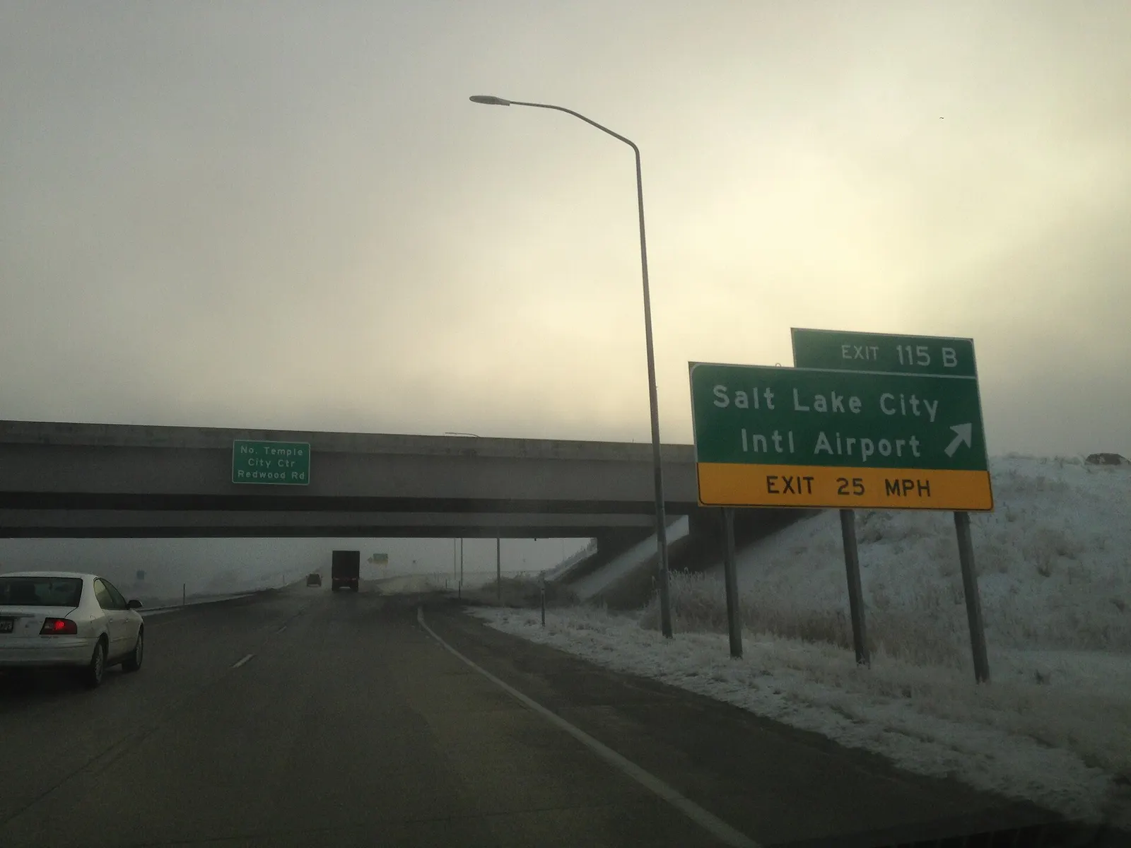 Green highway sign on I-80 eastbound marking the exit for Salt Lake City International Airport.