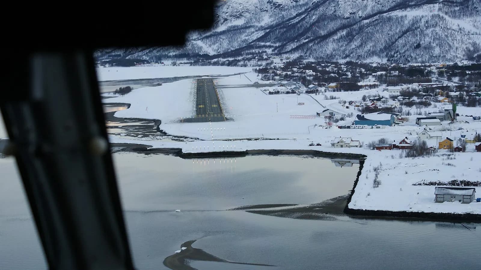 Sørkjosen Airport, Nordreisa, Troms, Norway. Runway as seen from the cockpit of Widerøe de Havilland Canada Dash-8 103 during approach from the north over southern Reisafjorden.