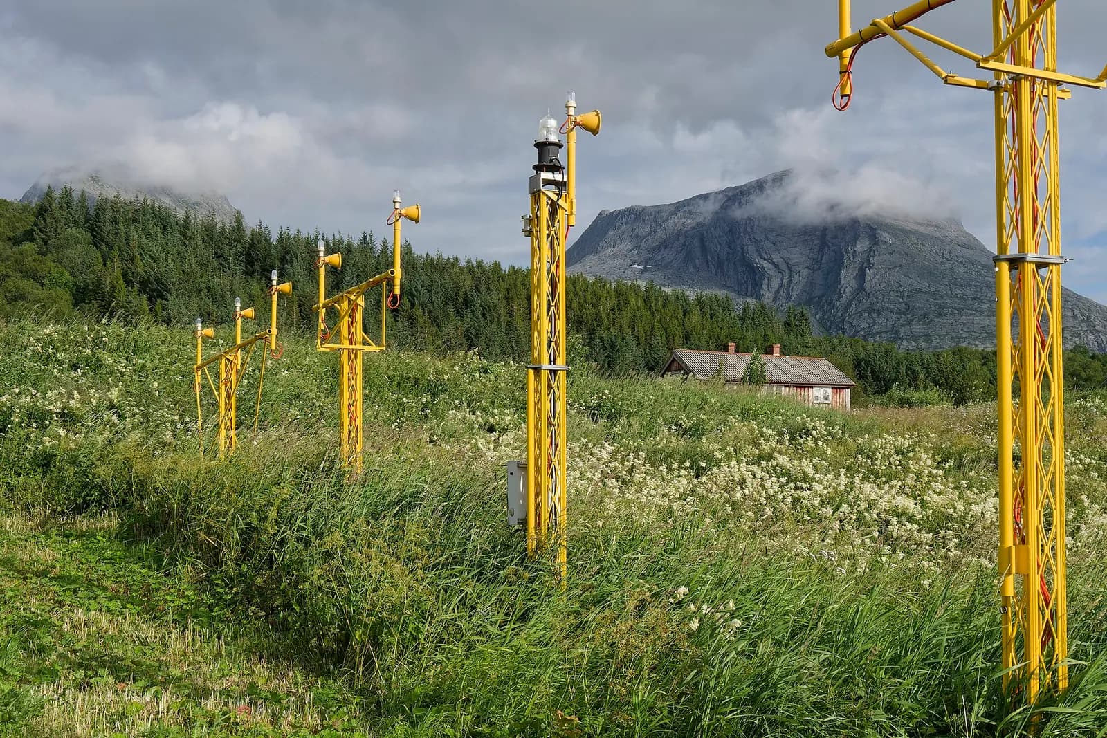 Approach lights at Sandnessjøen Airport, Nordland, Norway. In the background the southwestern end of the Sju søstre mountain range is visible.