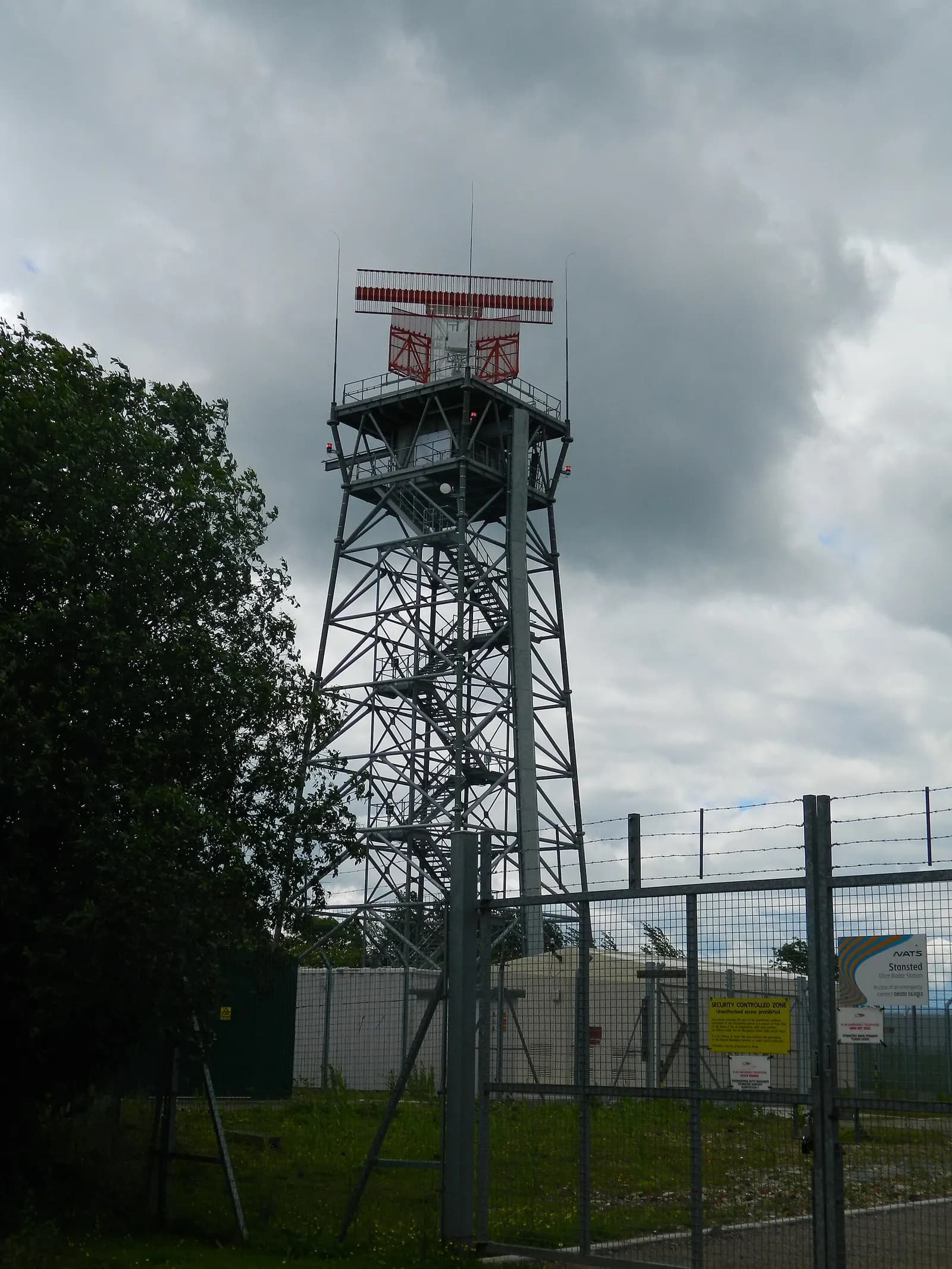 The air traffic control tower rising above the buildings at London Stansted Airport.