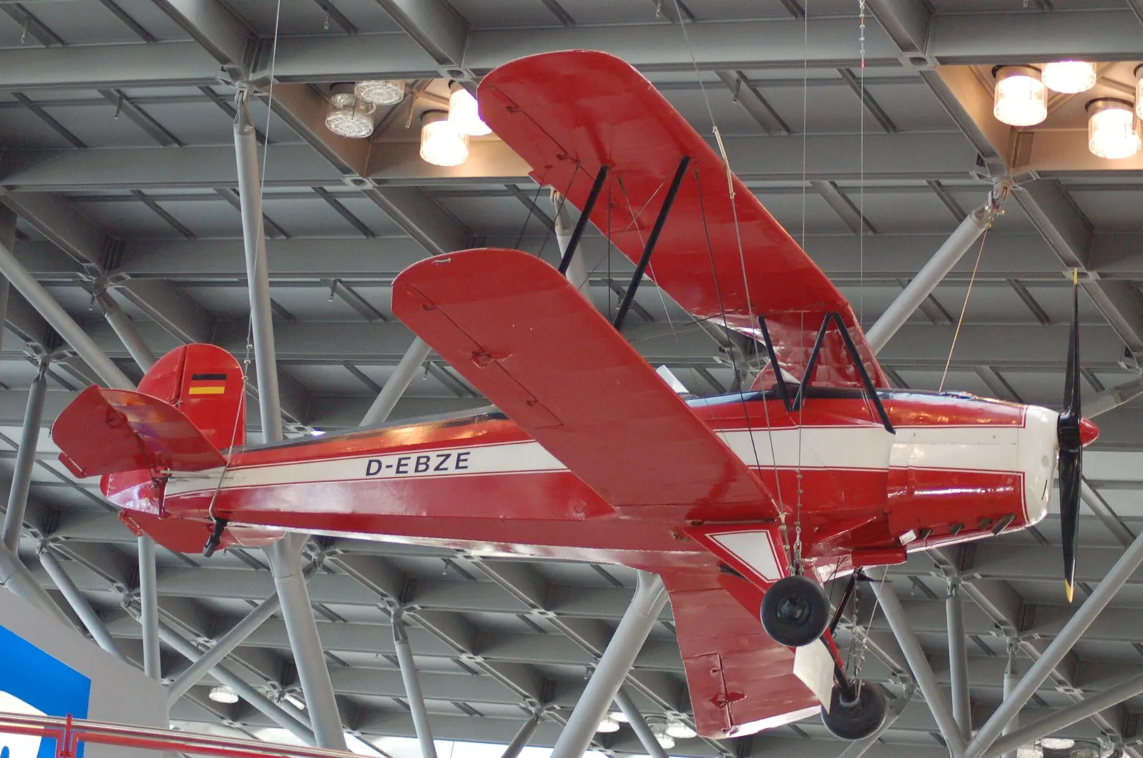A vintage Bucker Bu.131 Jungmann biplane displayed indoors as a heritage exhibit inside Terminal 1.