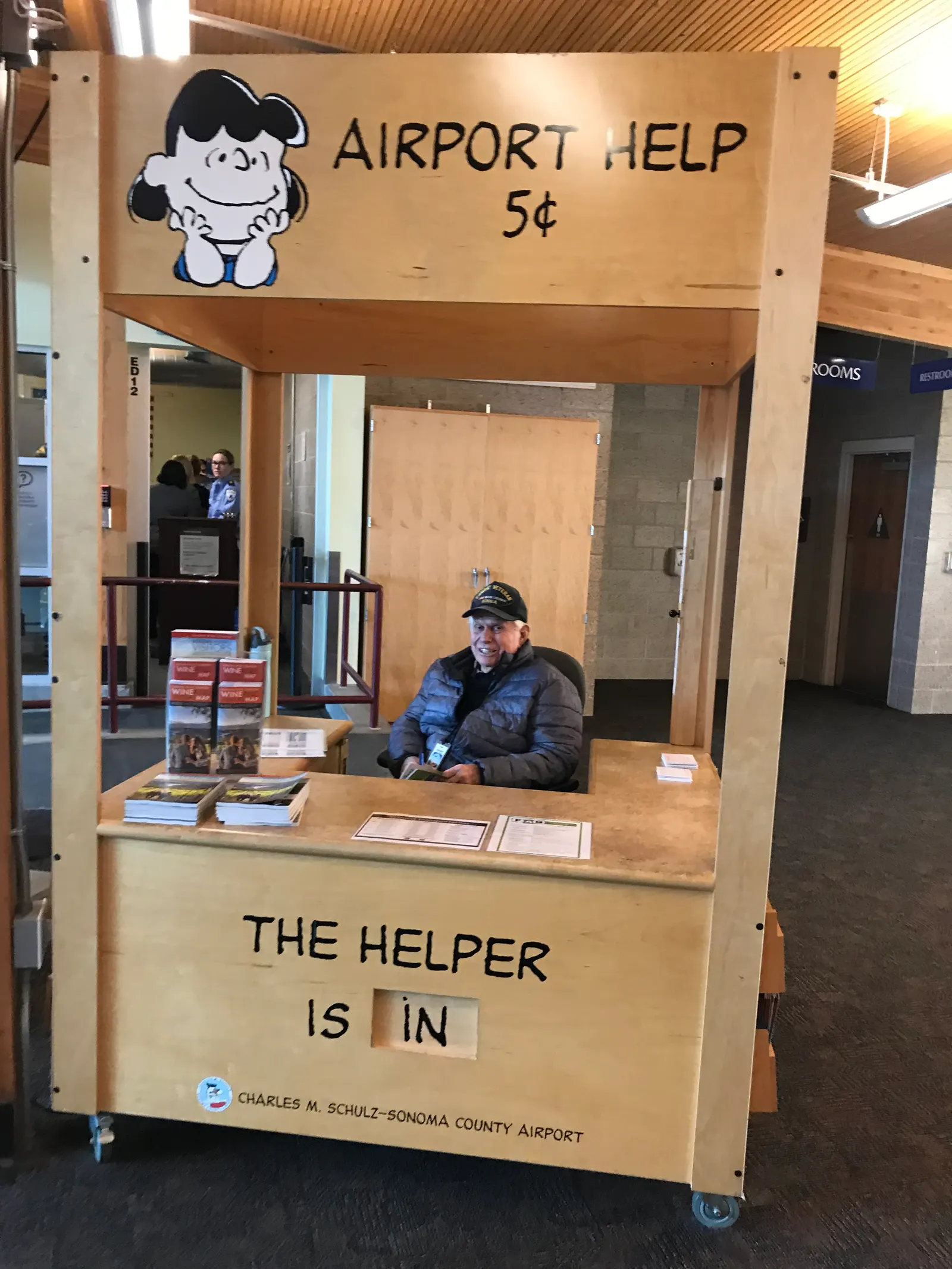 Lucy van Pelt Psychiatric Help information desk inside the STS terminal, photographed 4 March 2019. Public themed desk, not a commercial lounge.