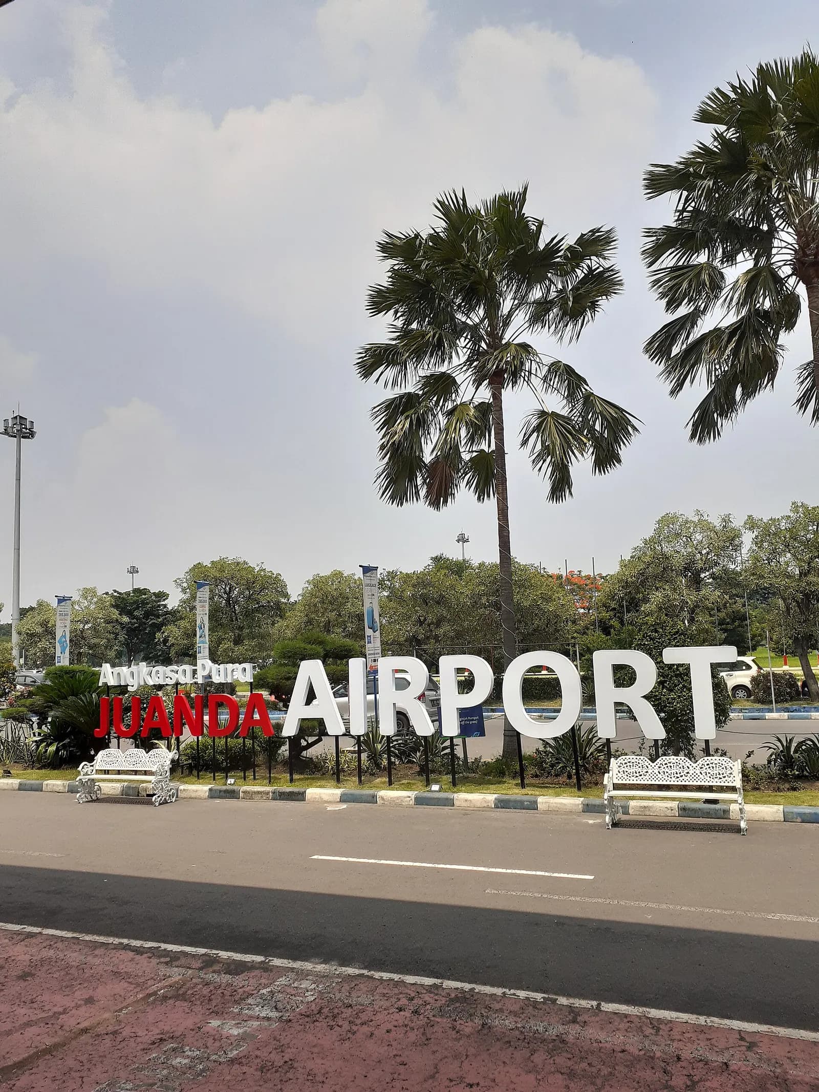 Juanda Airport roadside monument sign with Angkasa Pura branding in Sidoarjo, East Java