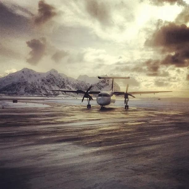 Widerøe Dash 8 at Svolvær Airport, Helle with Lofoten peaks behind