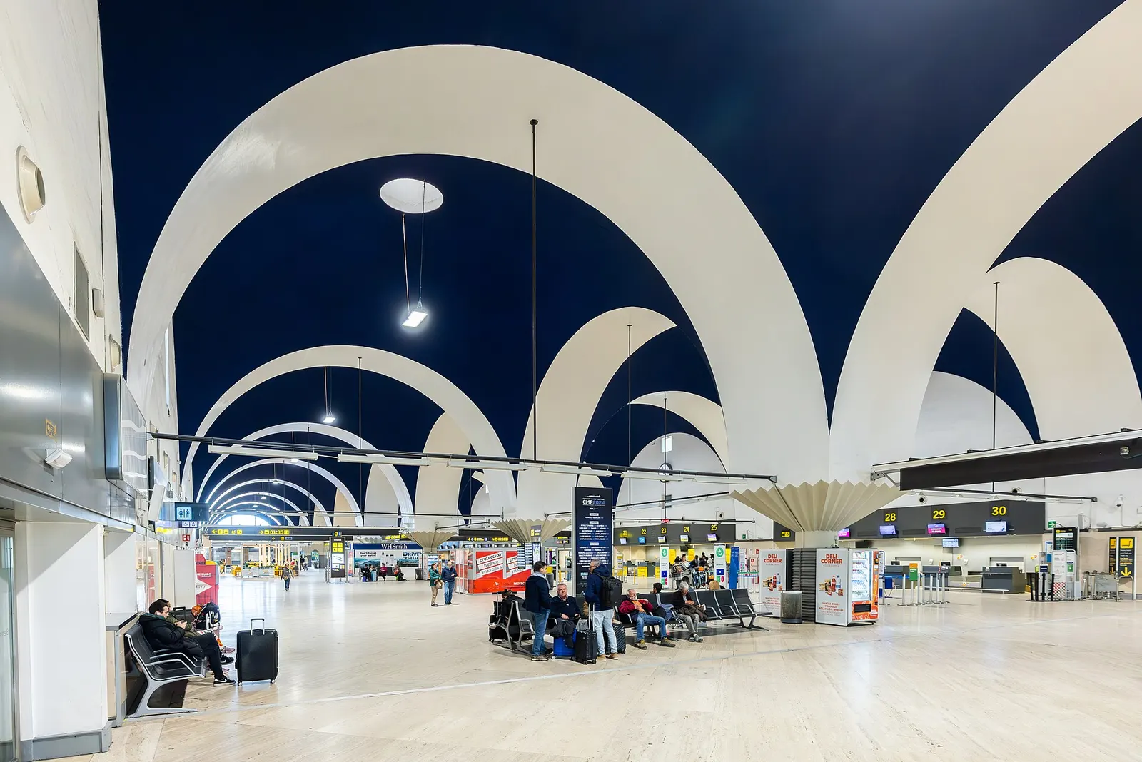 Landside view of Seville Airport terminal building and curb.