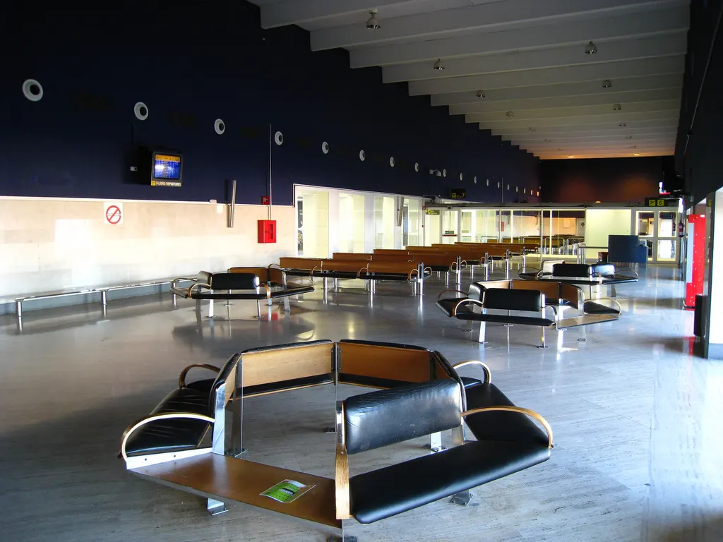 Airside boarding hall seating and windows at Seville Airport.