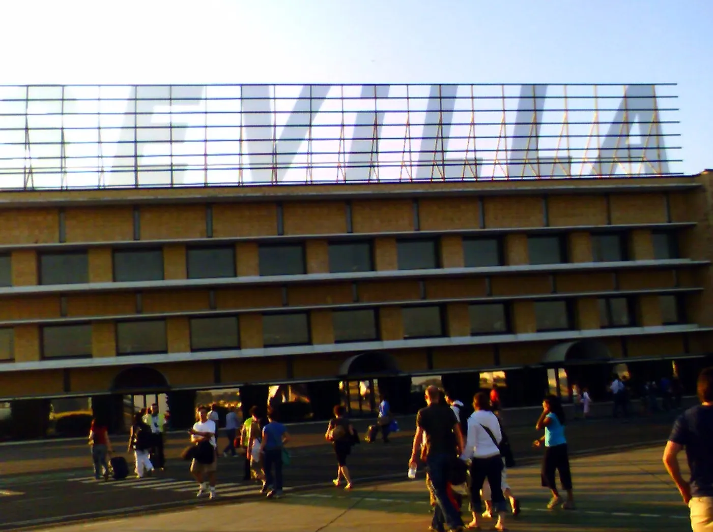 Wide exterior view of San Pablo Airport terminal and surrounding apron.