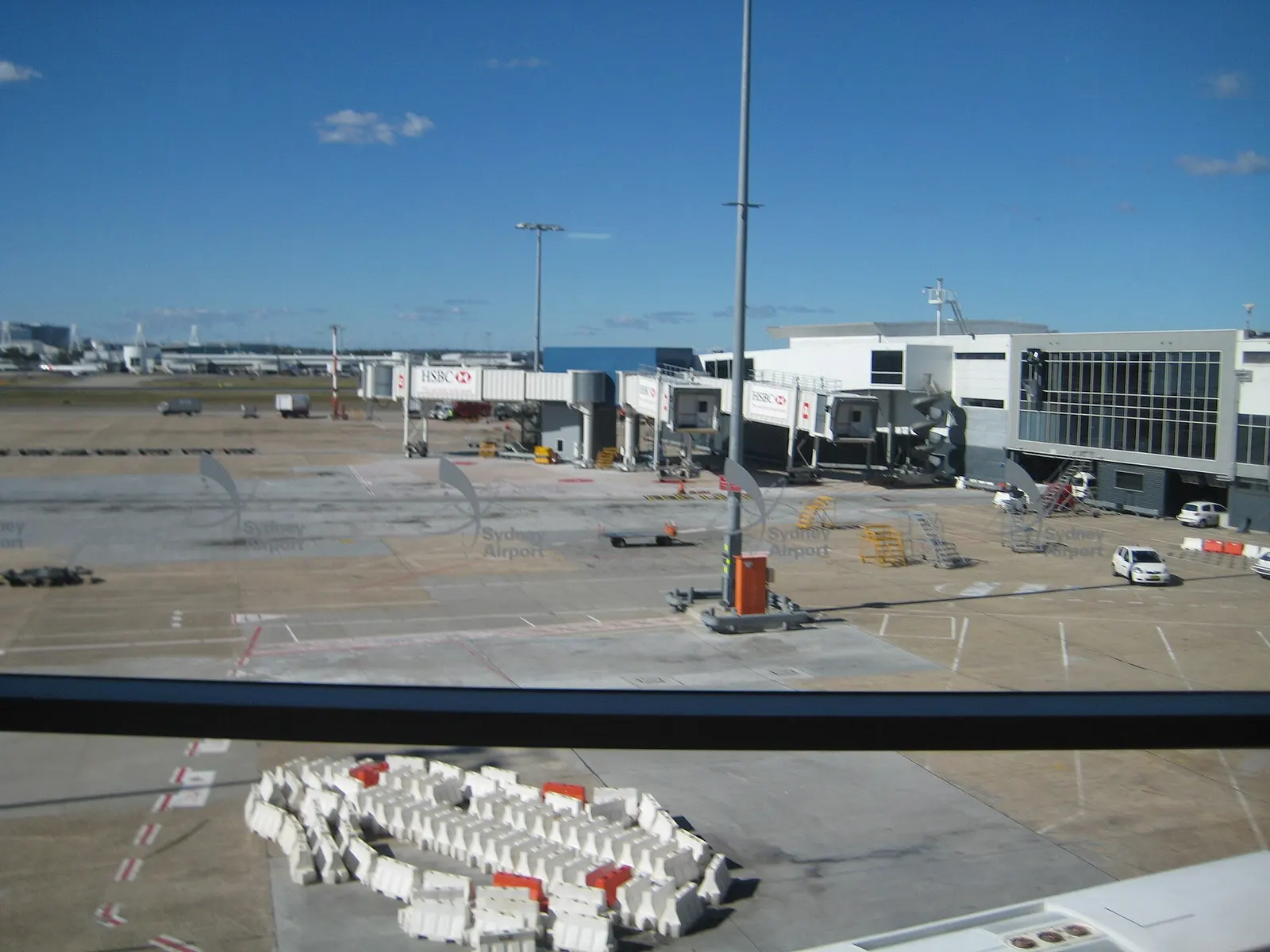 International boarding gates with seating areas and overhead flight information displays at Sydney Airport.
