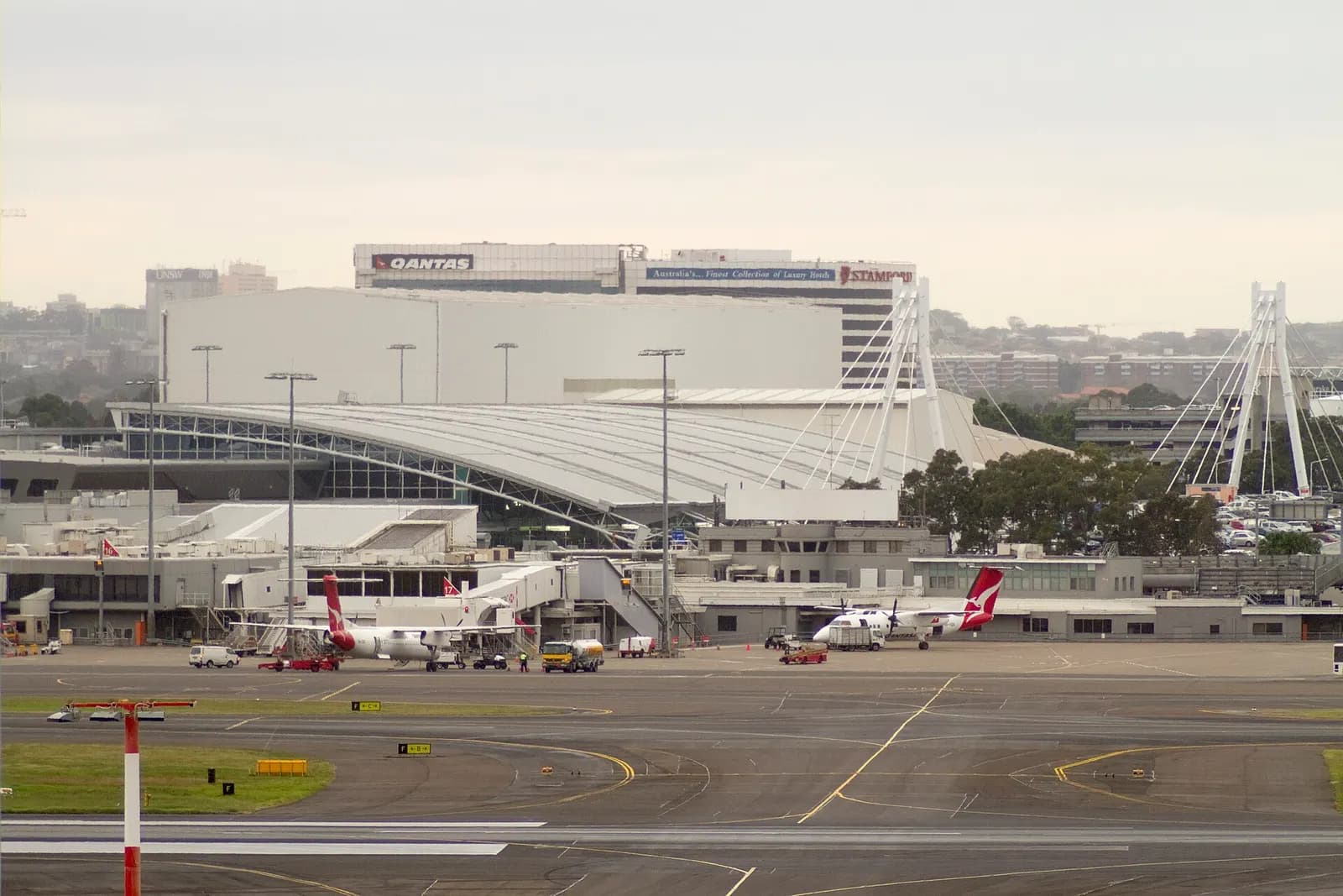 The multi-level domestic terminal complex with parked aircraft at gates and roadways in the foreground.
