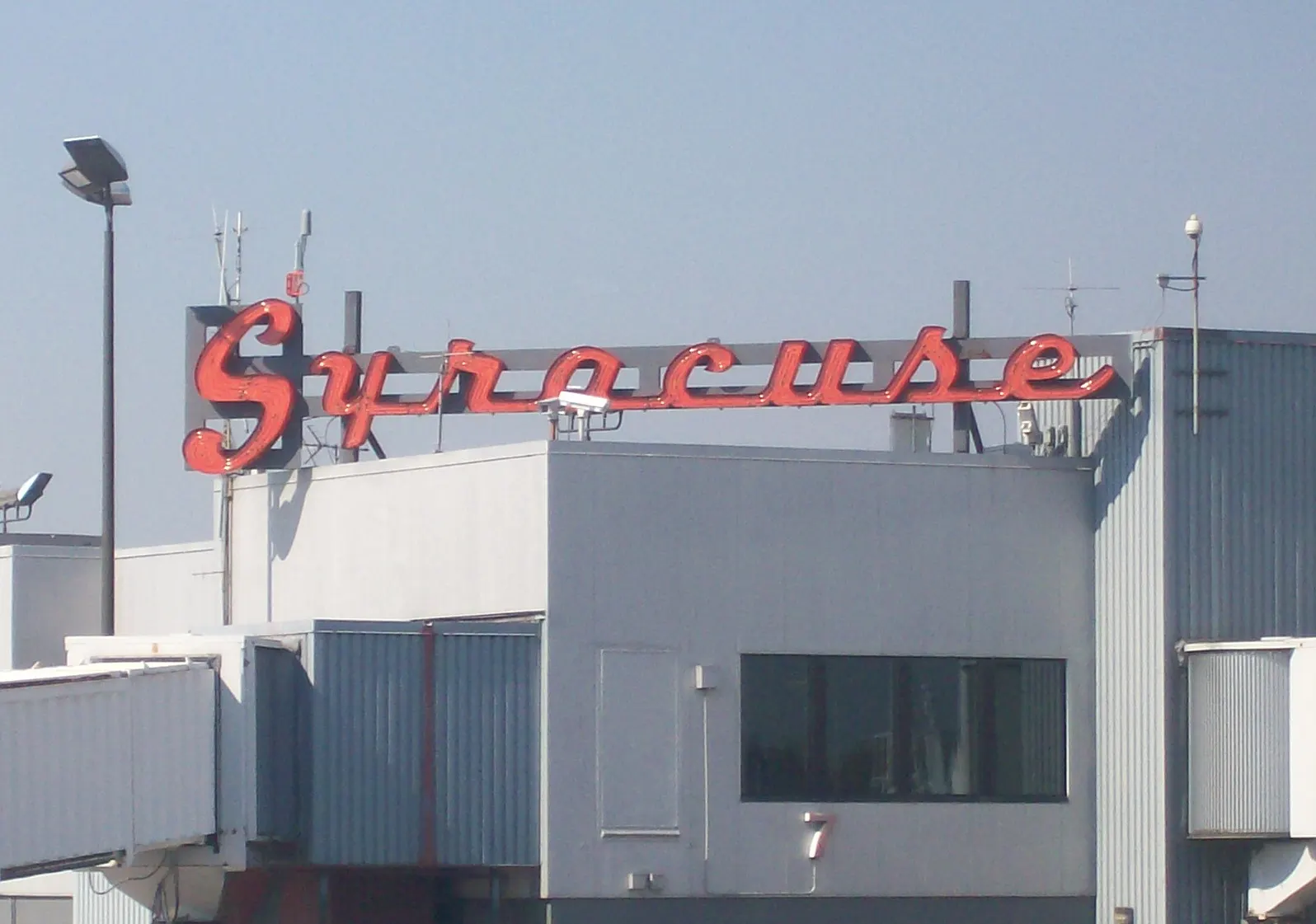 Roadside entrance sign reading Syracuse Hancock International Airport, photographed in October 2007.