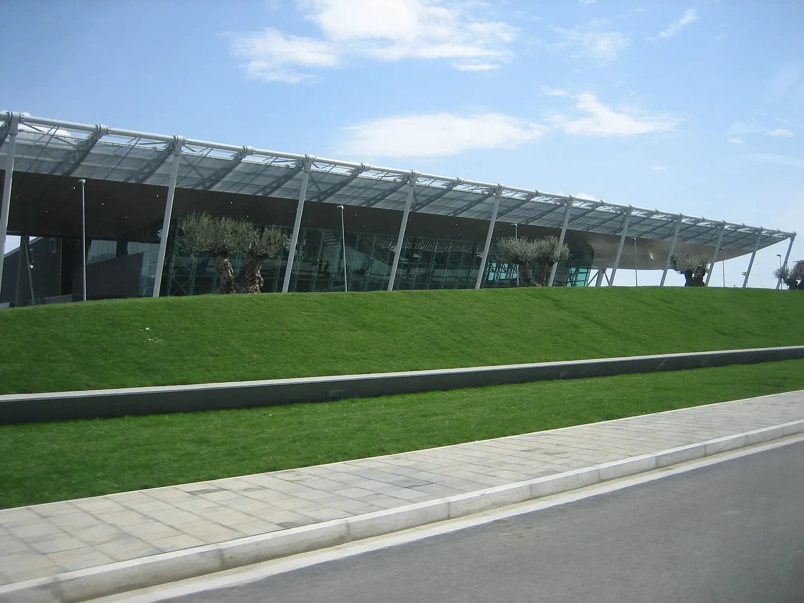 Exterior of Tirana Nënë Tereza International Airport terminal building with olive trees along the embankment, March 2007