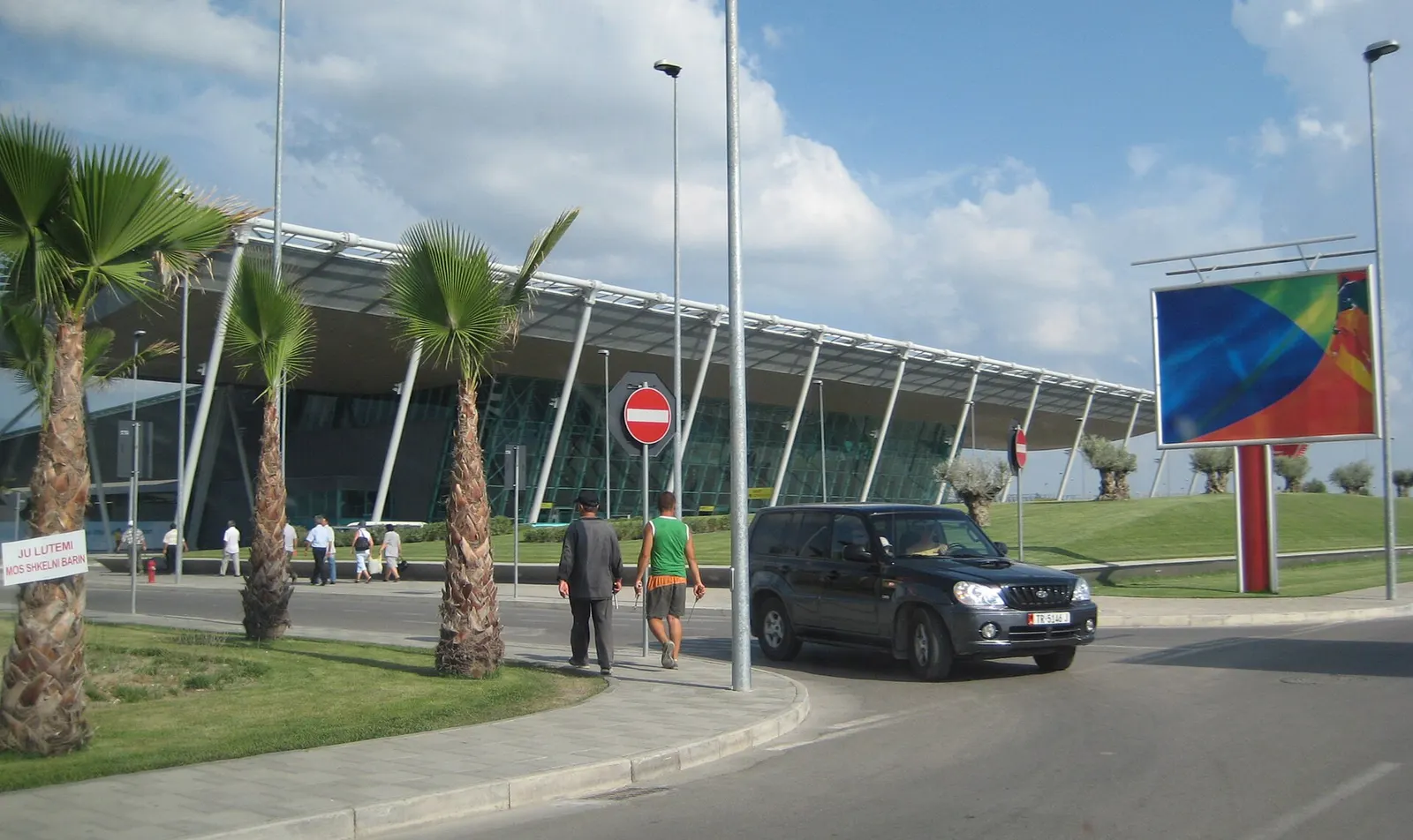 Rinas / Tirana Mother Teresa Airport new terminal exterior with angled roof supports and approach road