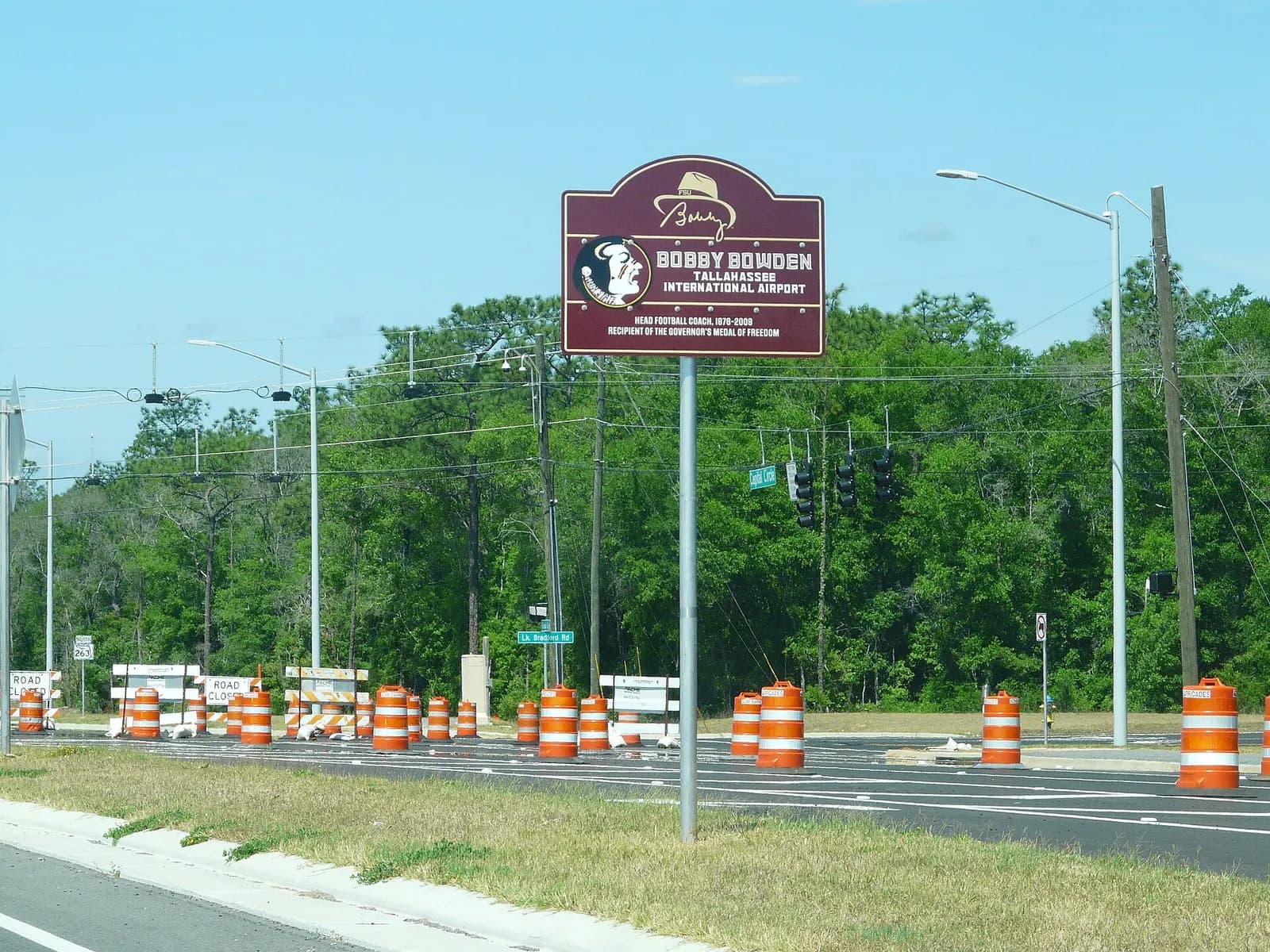 Roadway sign reading Bobby Bowden Tallahassee International Airport on the approach to TLH.