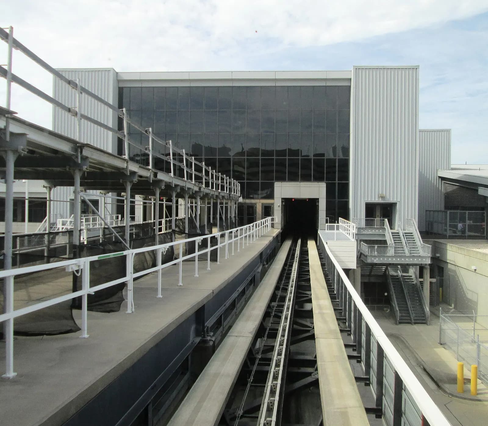 View from the front window of a shuttle train traveling on an elevated guideway toward Airside E at Tampa International Airport.