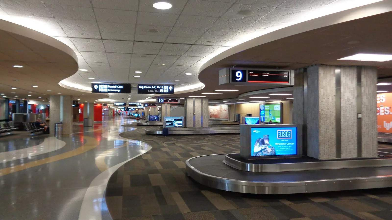 Baggage claim carousels and arriving passengers on Level 1 of Tampa International Airport's main terminal.
