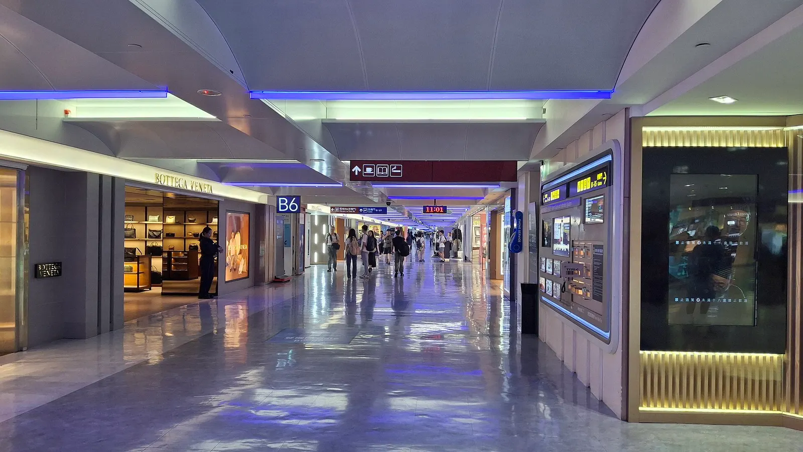 Terminal 1's exterior facade and entrance area are seen from the approach road, with the building's distinct architectural lines.