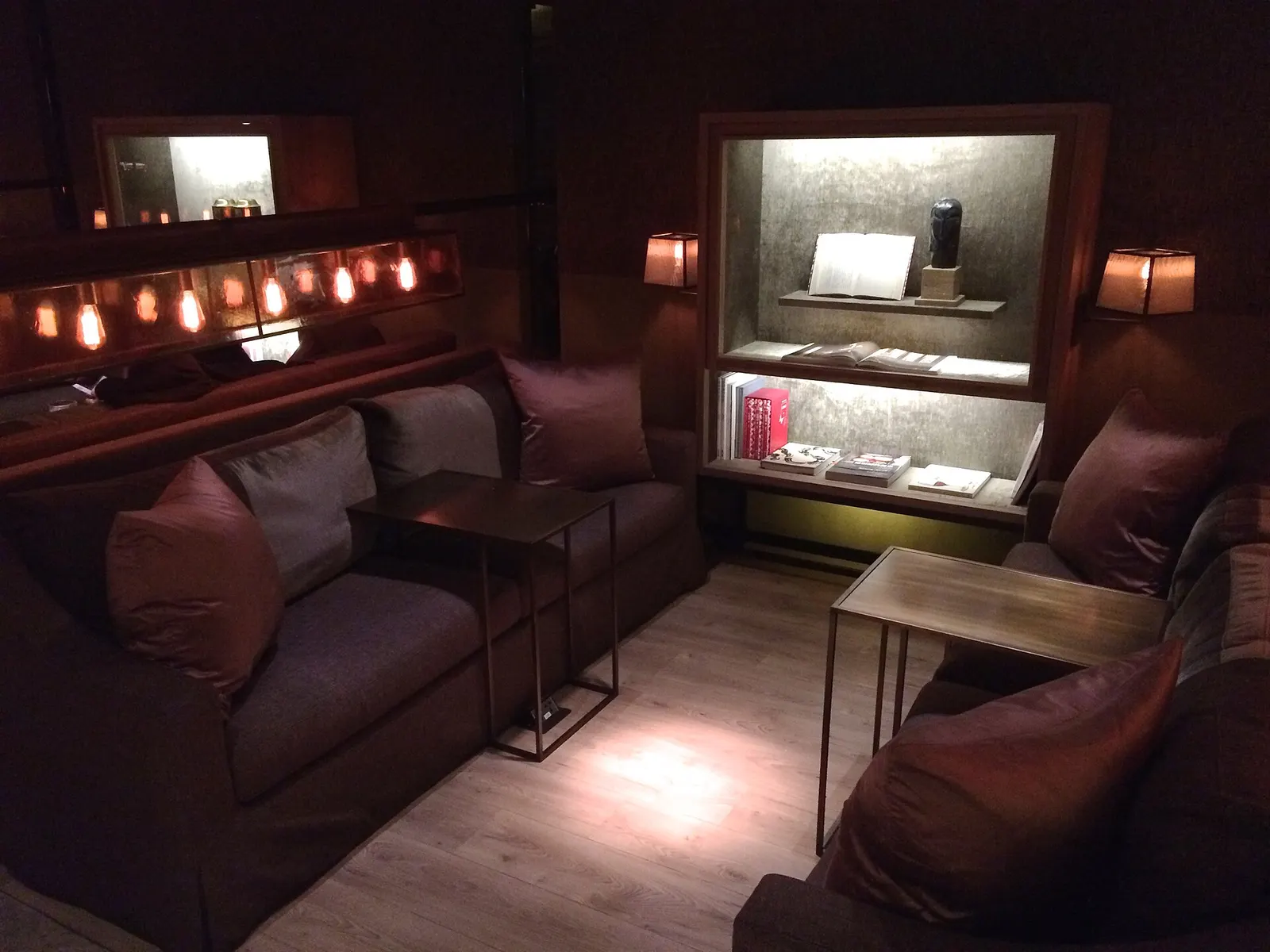 The China Airlines business-class lounge in Terminal 1 has seating areas, tables, and a buffet counter for waiting passengers.